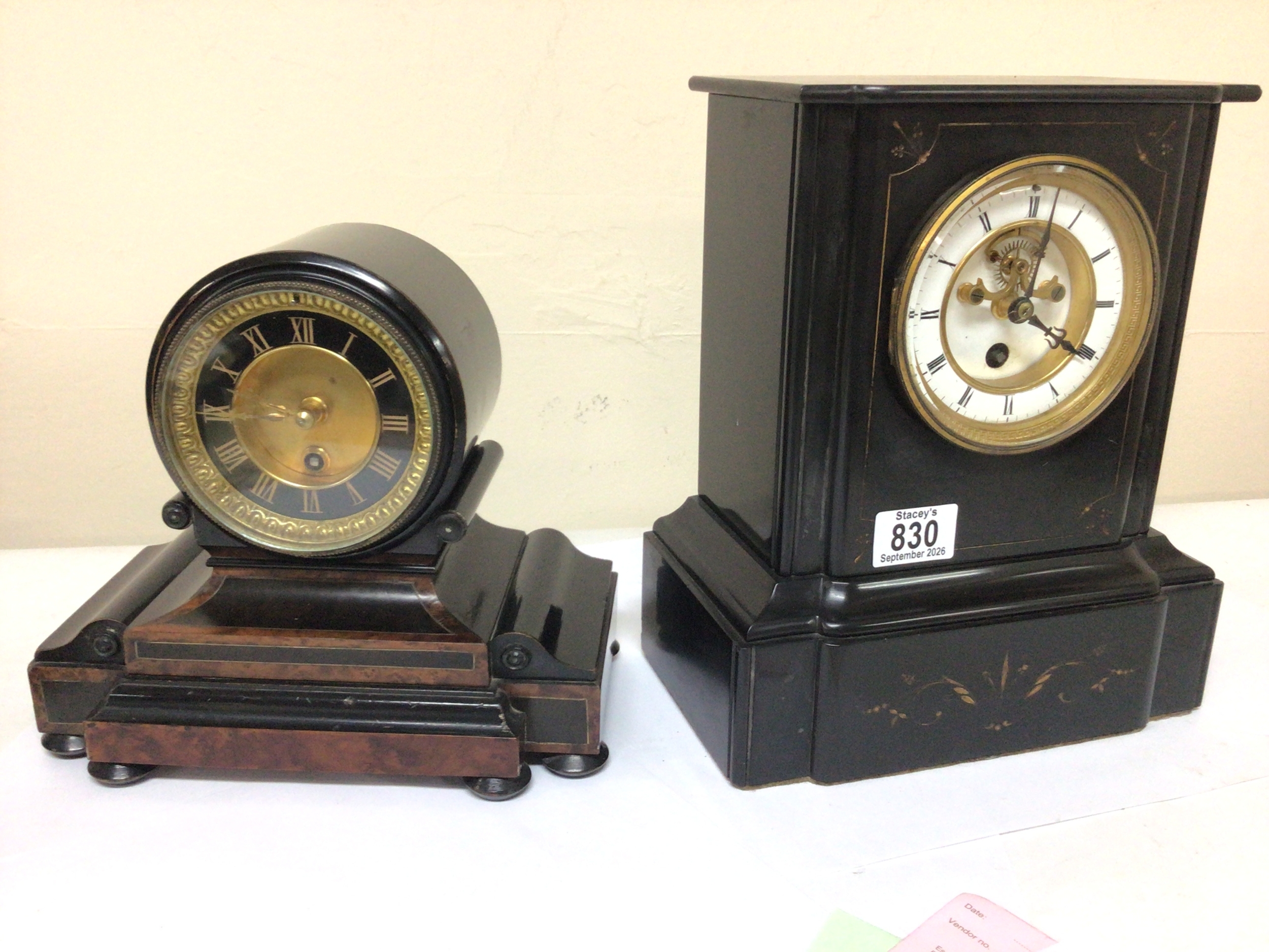 A Victorian black slate mantel clock with a visible escapement French movement with pendulum seen working and one other Victorian walnut and ebony veneered wall clock (2)