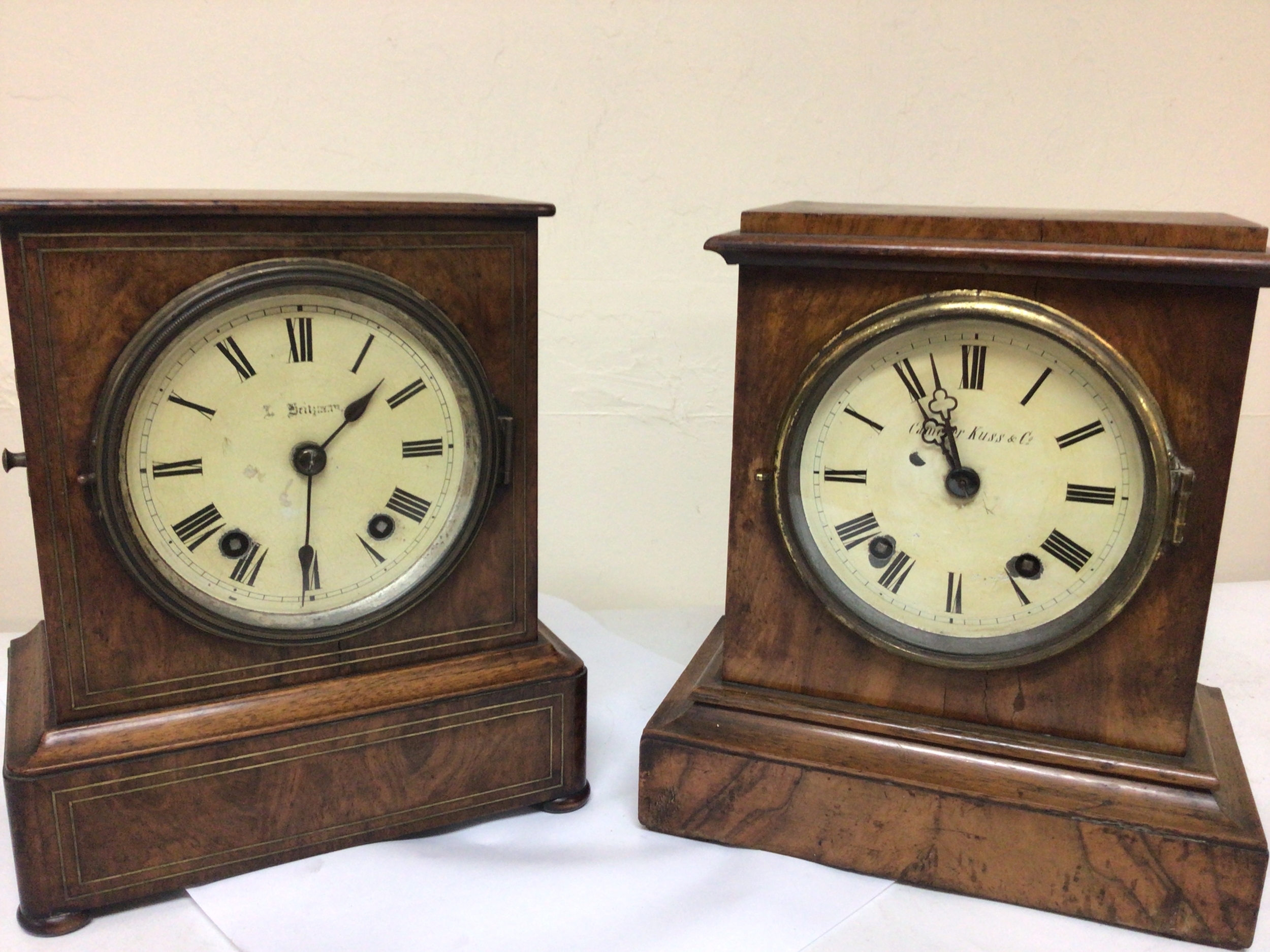 Two Victorian walnut cased mantel clocks maker Camerer Cuss & Co and one other both with brass movements striking on gongs with pendulum attached. Seen working height 27cm (2) NO RESERVE