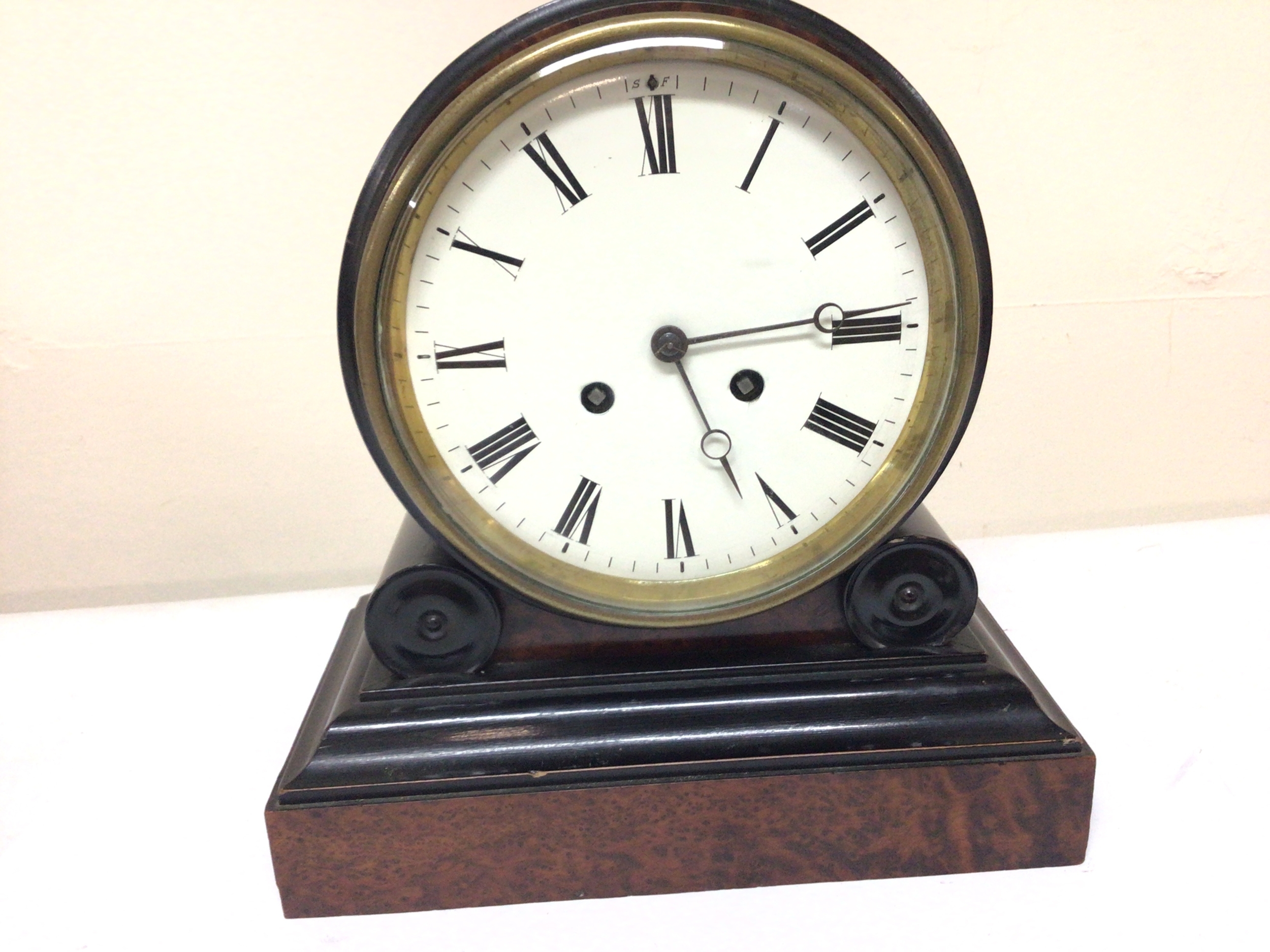 A Nice quality Victorian mantel clock with a white enamel dial in a walnut and ebony case with a brass French movement striking on a bell with pendulum attached. Hight 27cm.