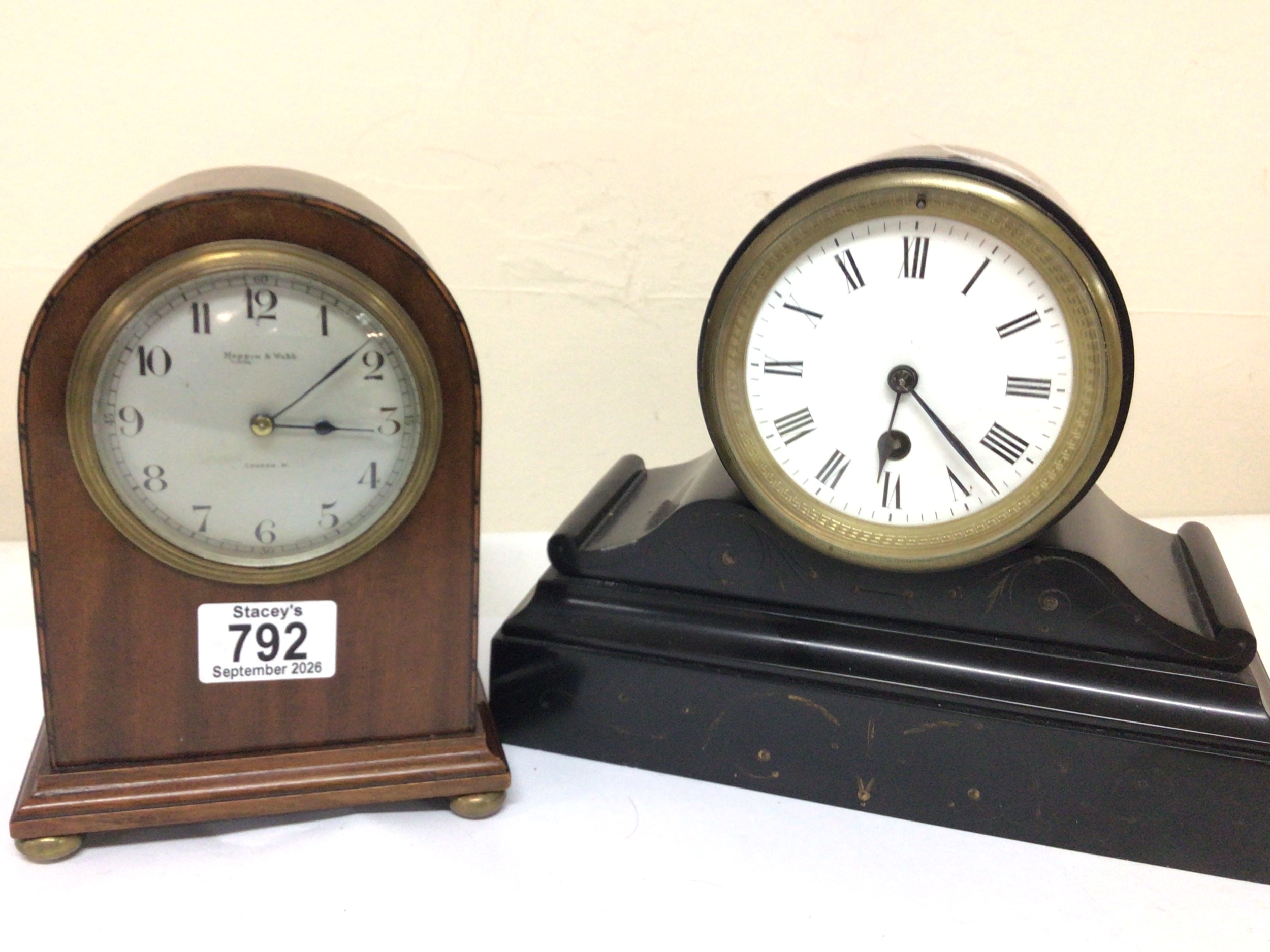 A Mappin & Webb mahogany cased Mantel clock and a black slate clock with an enamel dial brass French movement and with pendulum. Maximum height 21cm (2) NO RESERVE