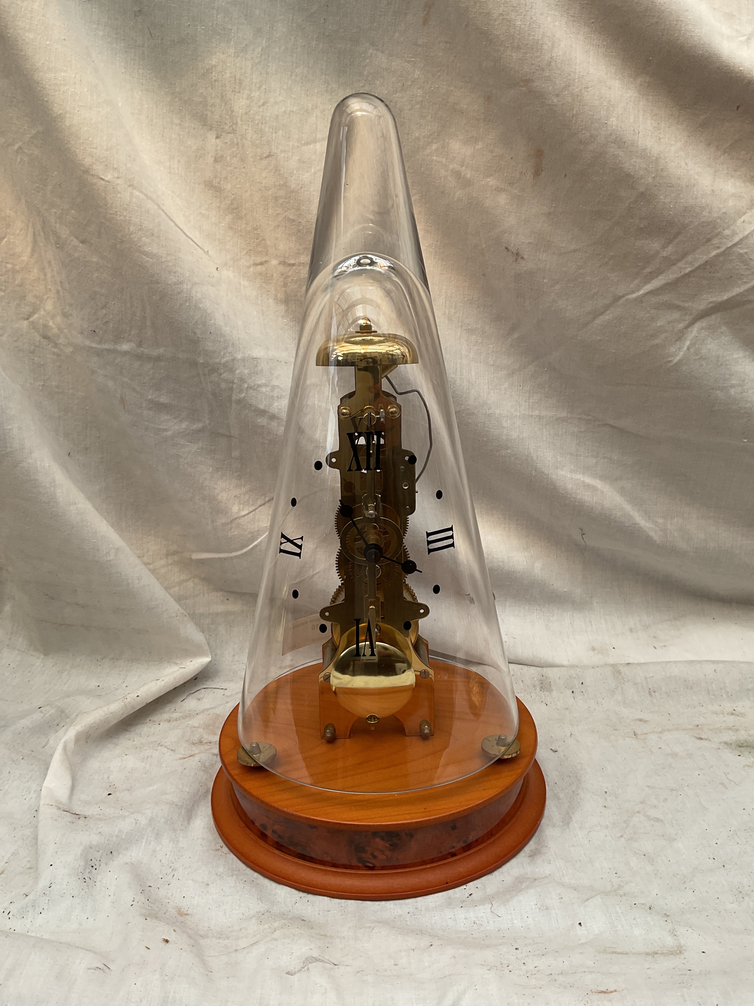 Franz Hermle striking clock under glass numeral cone.