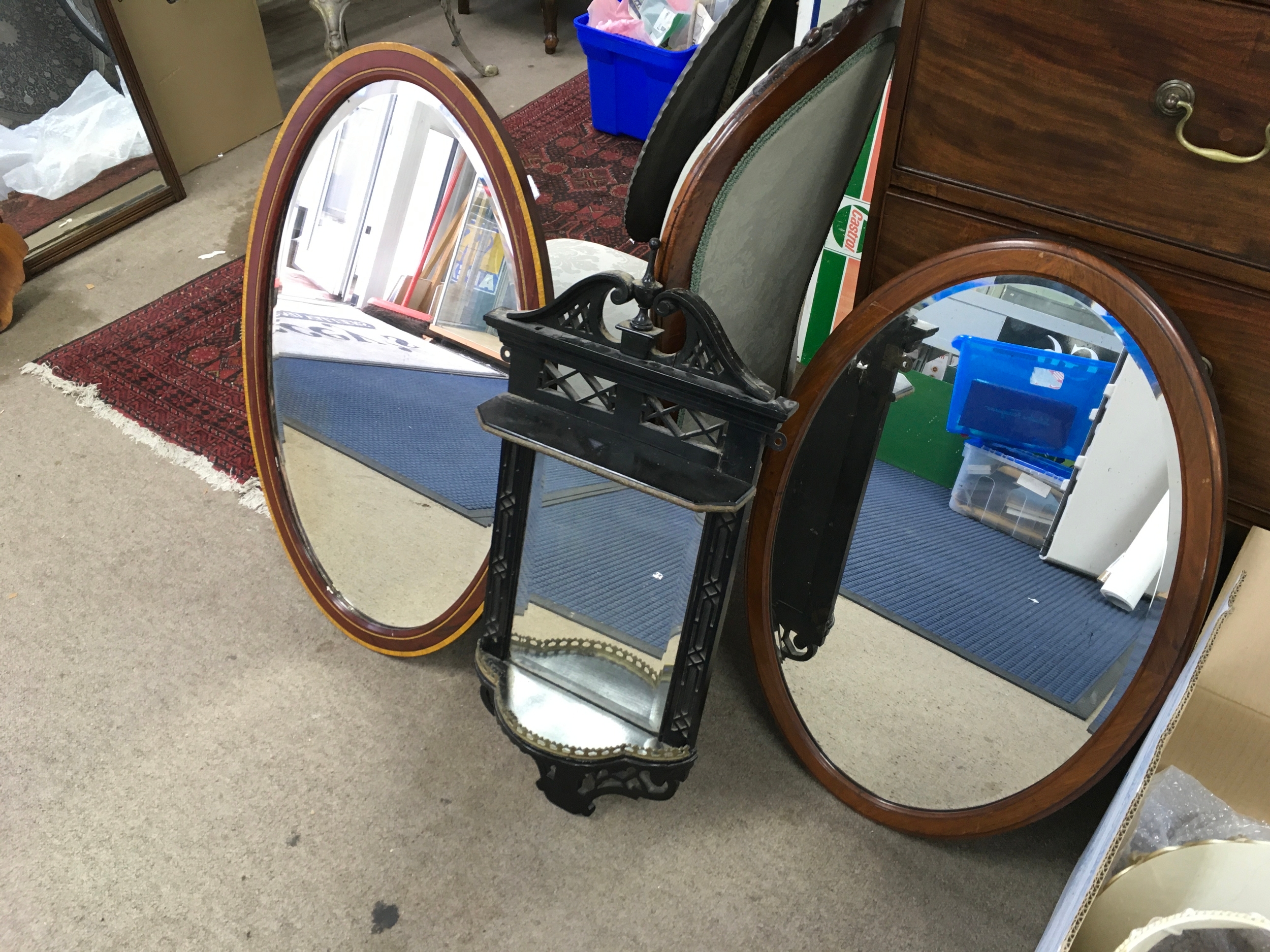 wooden wall-mounted mirror sconce and two mirrors.
