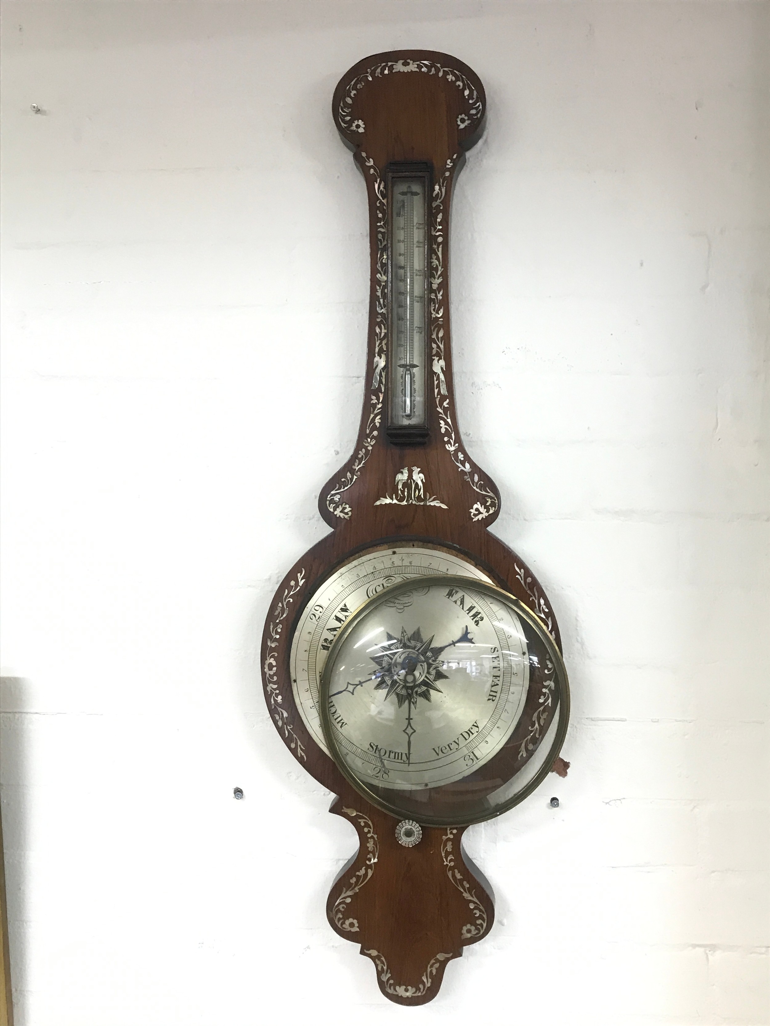 A Victorian rosewood inlaid barometer.