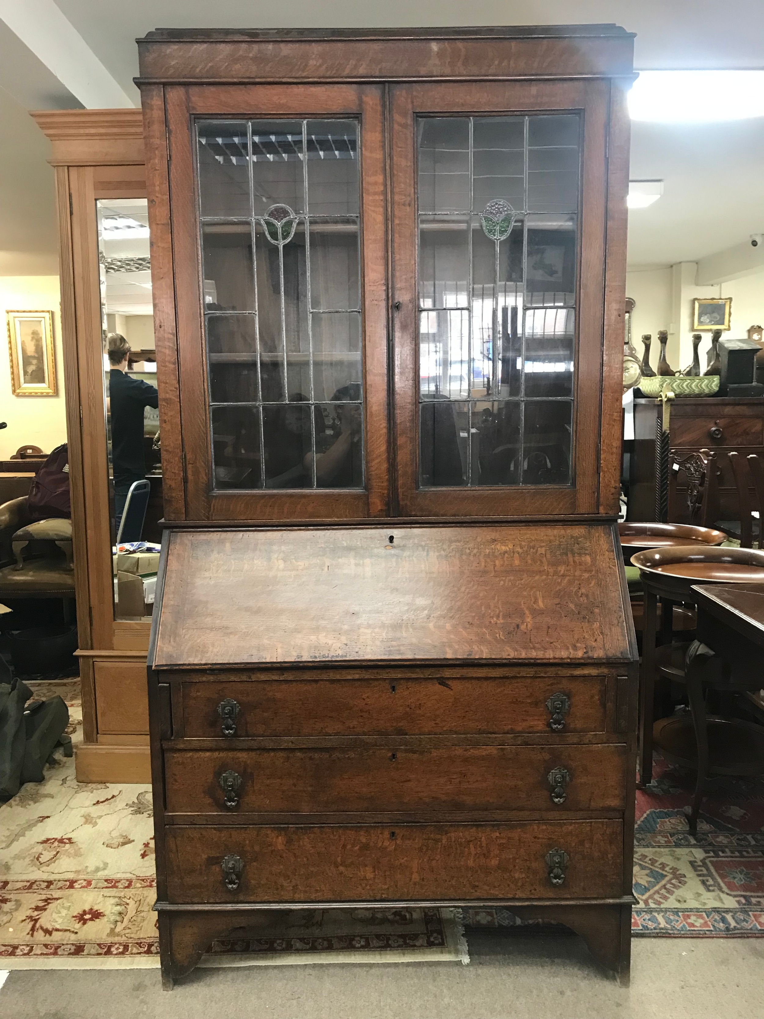 An oak bureau bookcase featuring stained glass doors. 100cm wide, 41cm long, 198cm tall