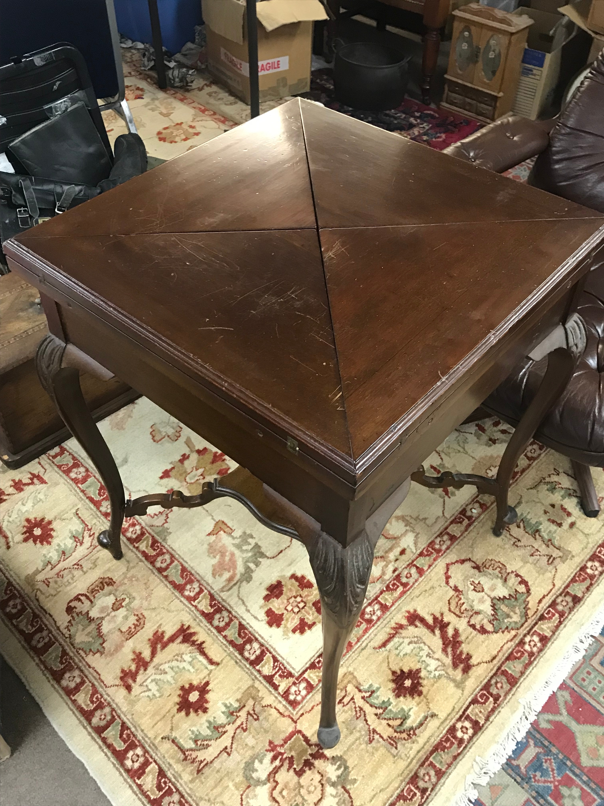 A mahogany envelope card table featuring folding triangular leave. 56cm wide 56cm long 74cm tall