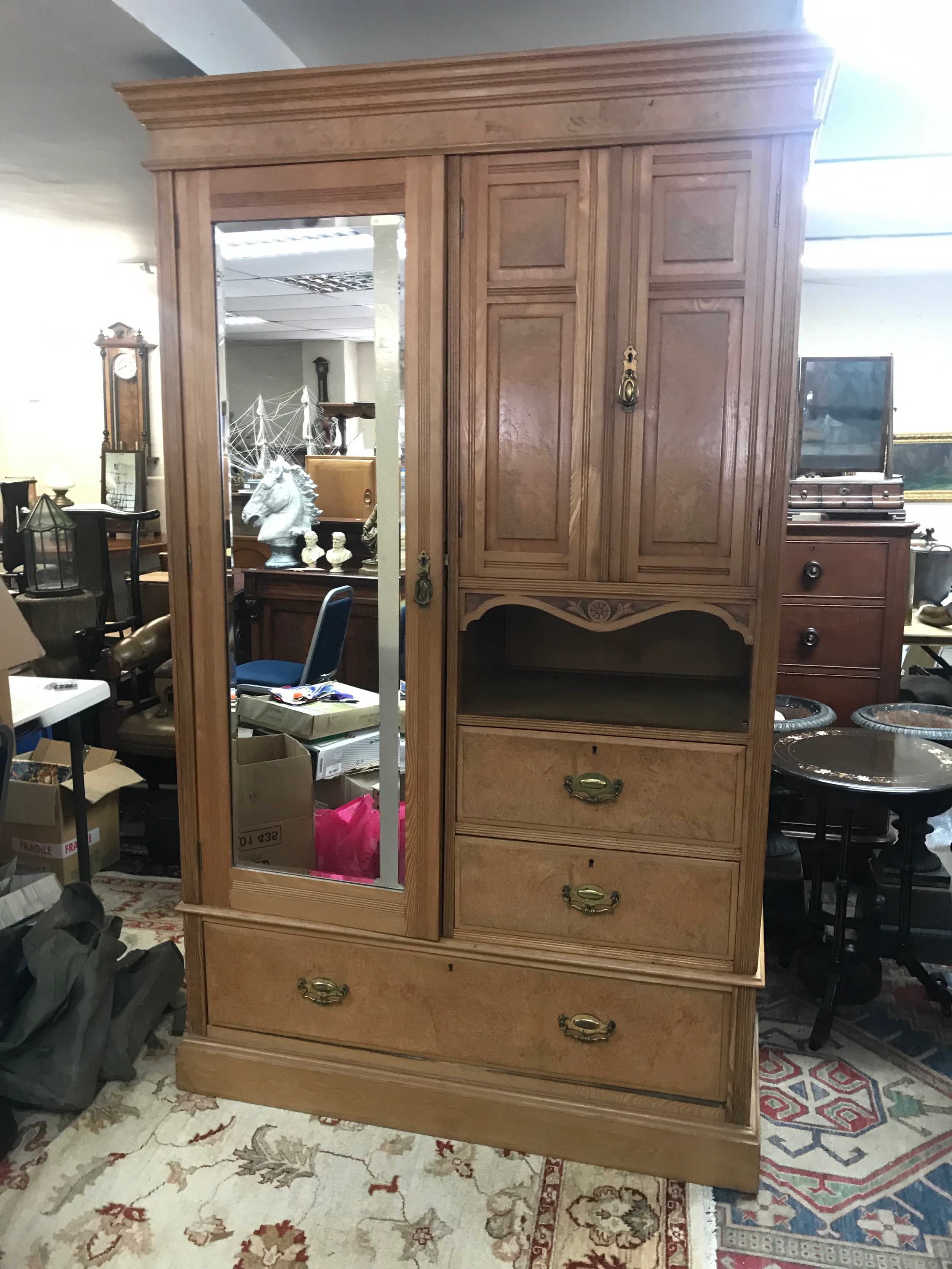 A large combination wardrobe featuring a single mirrored door, upper cupboards, an open display shelf, and multiple lower drawers. 212cm tall, 48cm long 124cm wide
