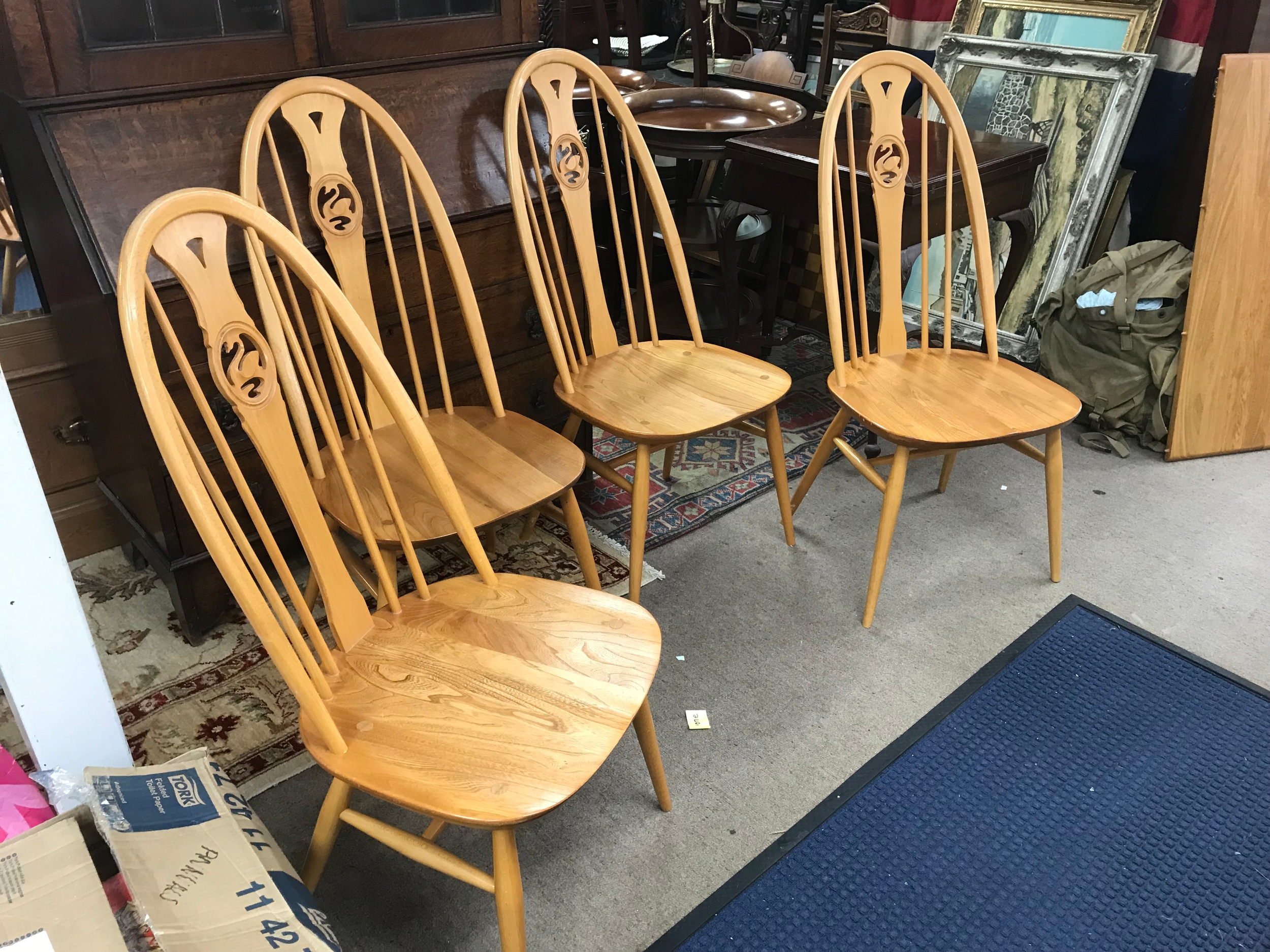 An Ercol table and four chairs, 111cm wide. Chairs 100cm tall, 44cm wide