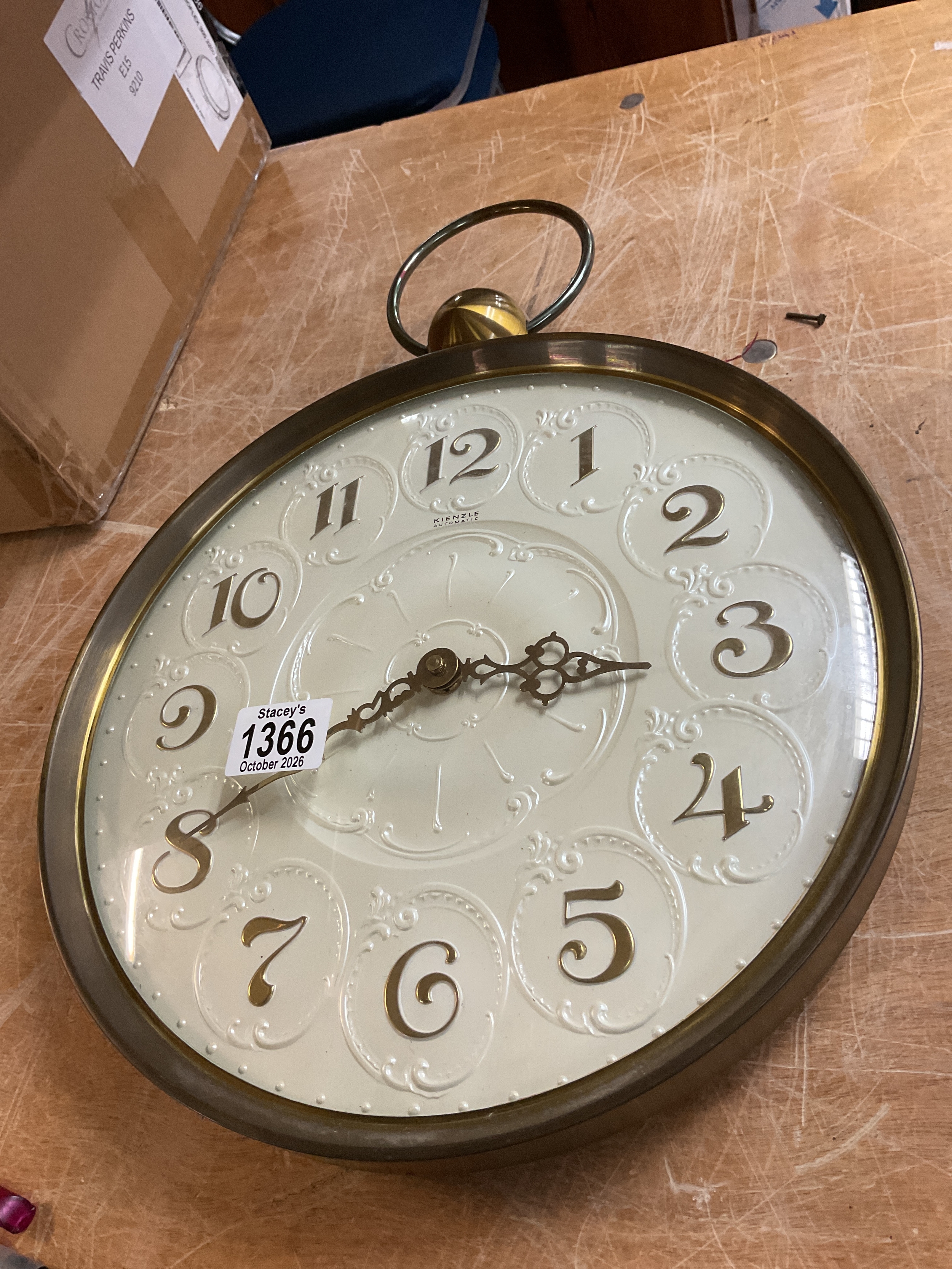 Kienzle wall clock with pearlized ornate face.