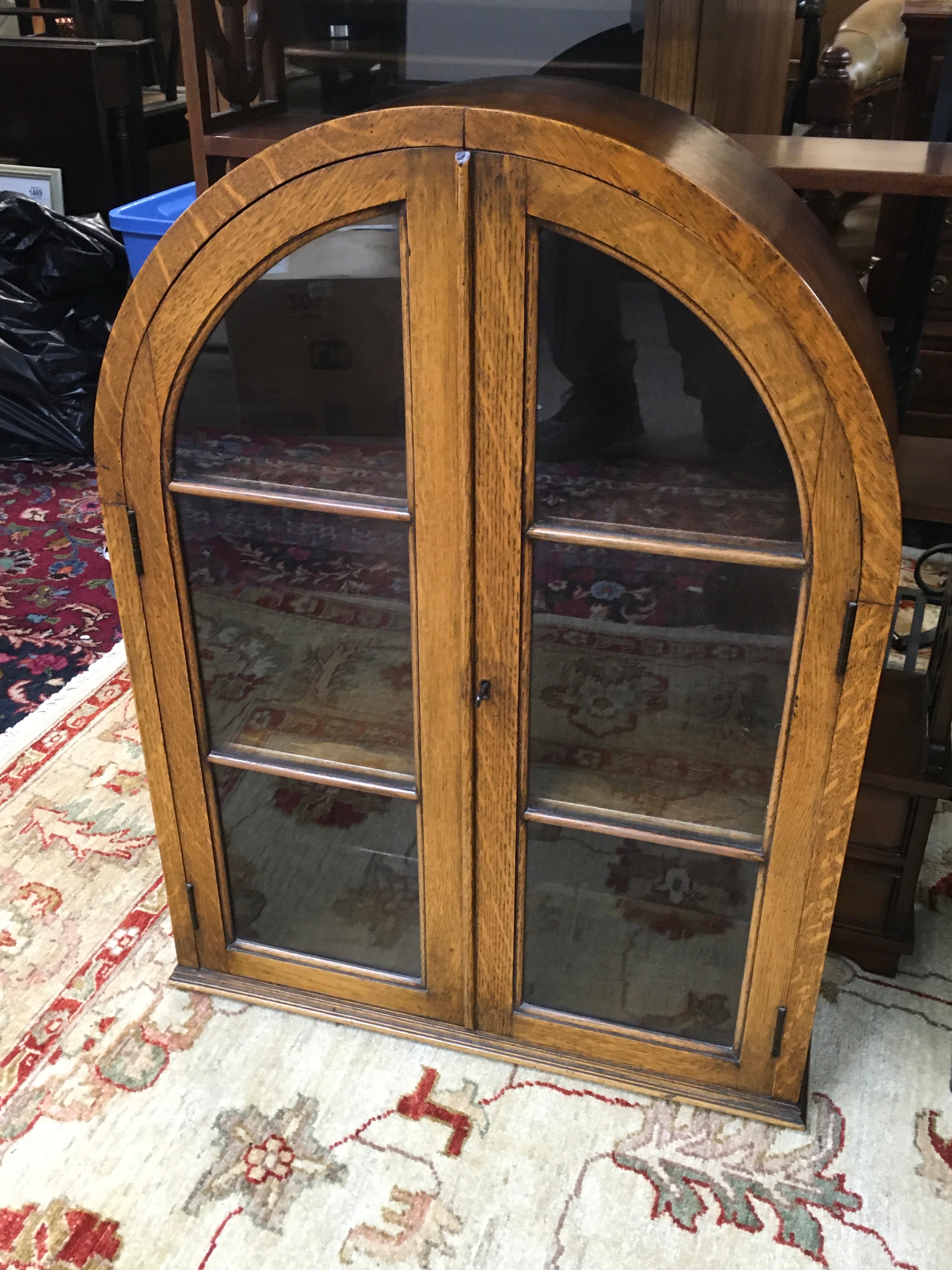 An arched-top oak display cabinet, 78cm tall