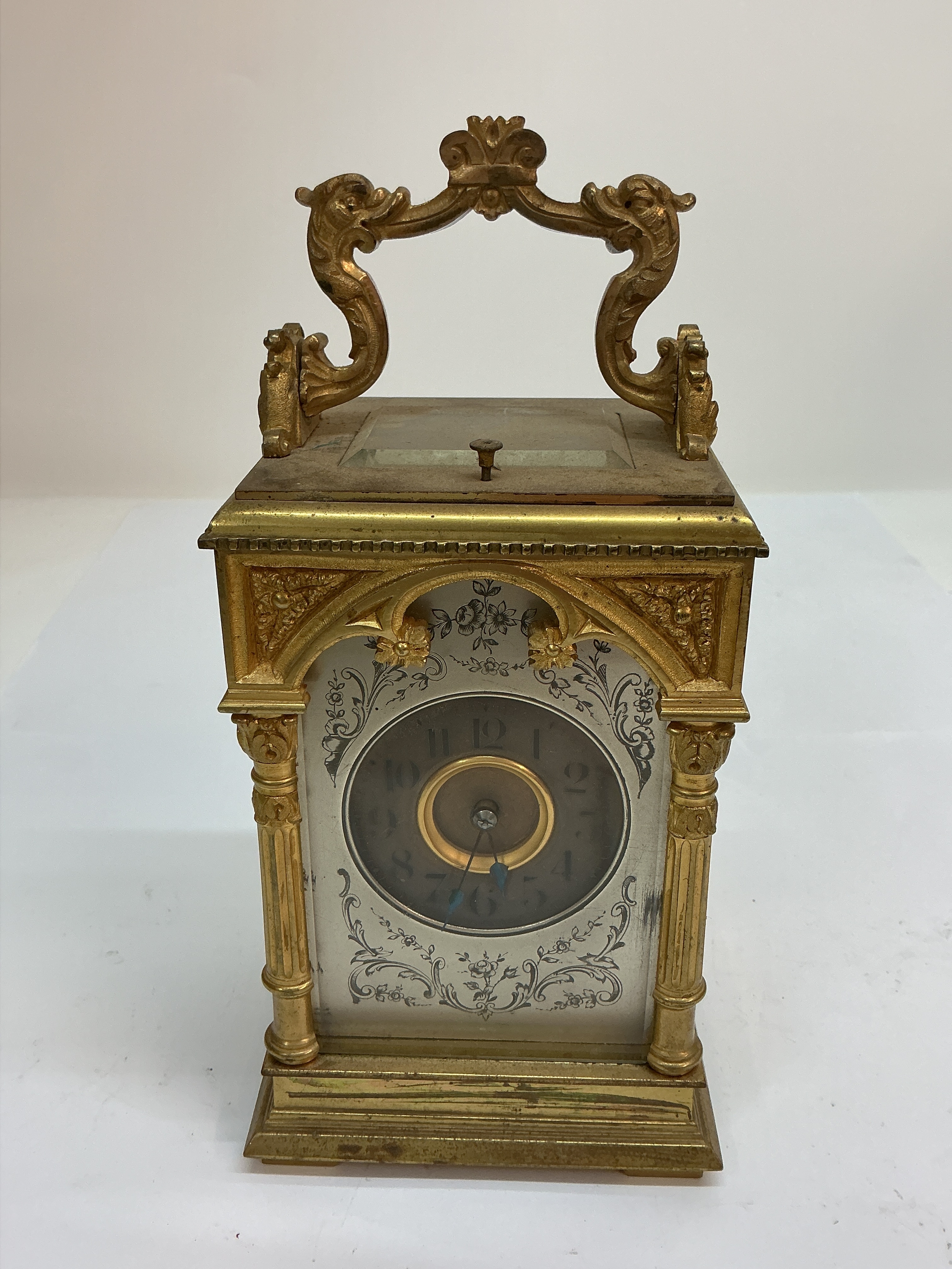 An elaborate strike repeat, gilt carriage clock with decorated dial. Approx: W10 x H15cm. 