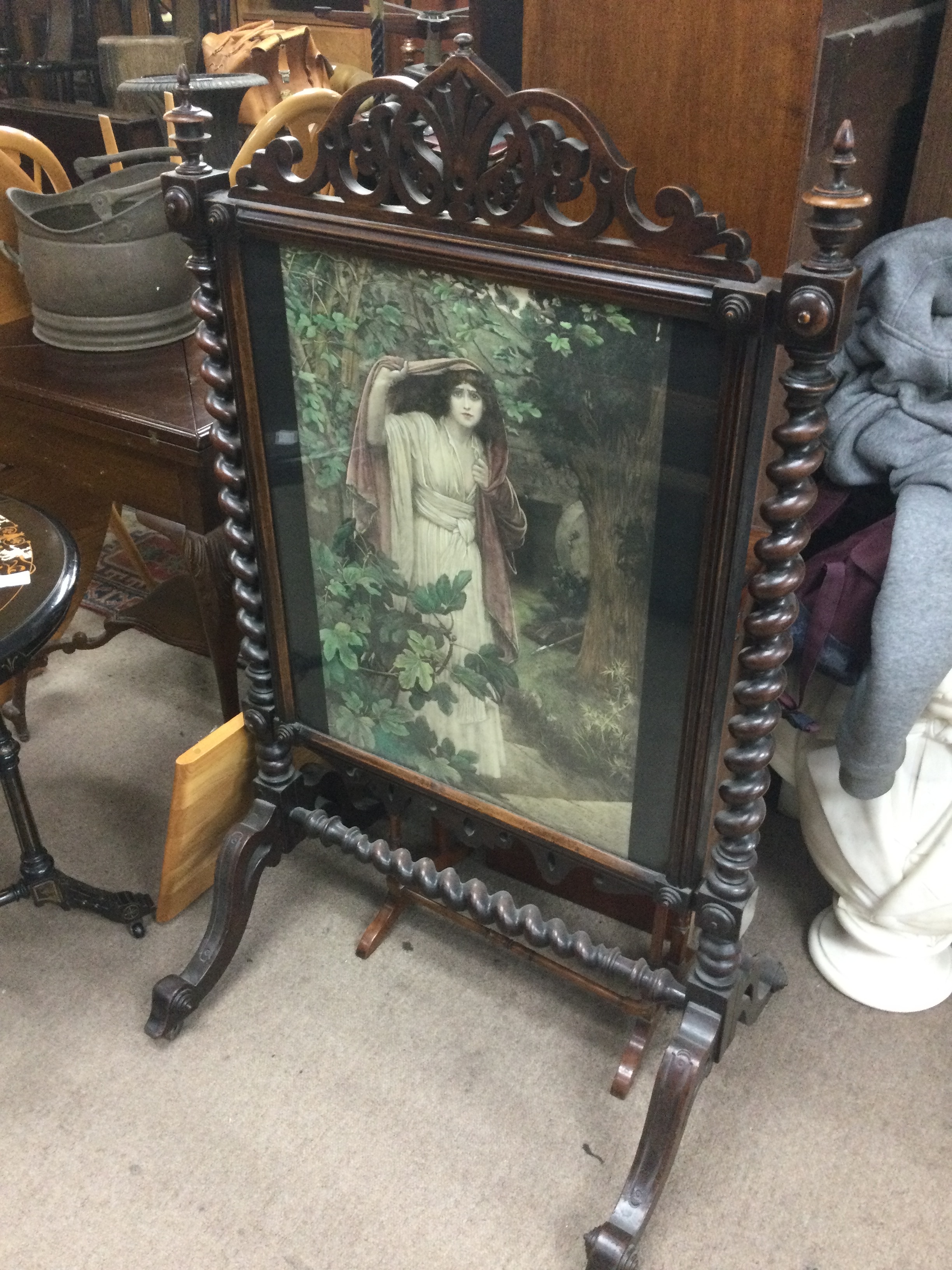 A Victorian fire screen with barely twist supports 