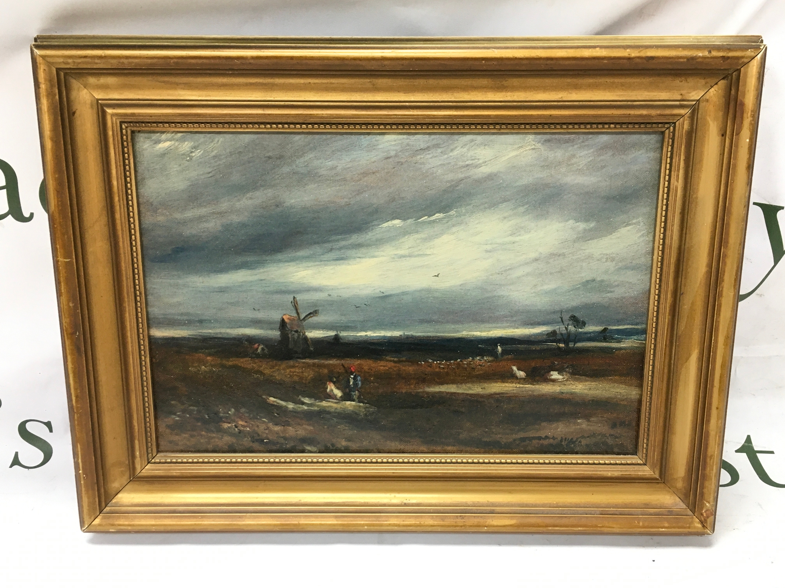 A gilt framed oil on canvas with label of John Constable (1776-1837) windmills and drovers in an estuary landscape. Museum no 73, property of Lord Kiddy. Reverse of the painting reads Lechertier Barbe & Co, Artists colourants, 60 Regent street, London. Painting 12x8 inches and its frame measures 15x11 inches