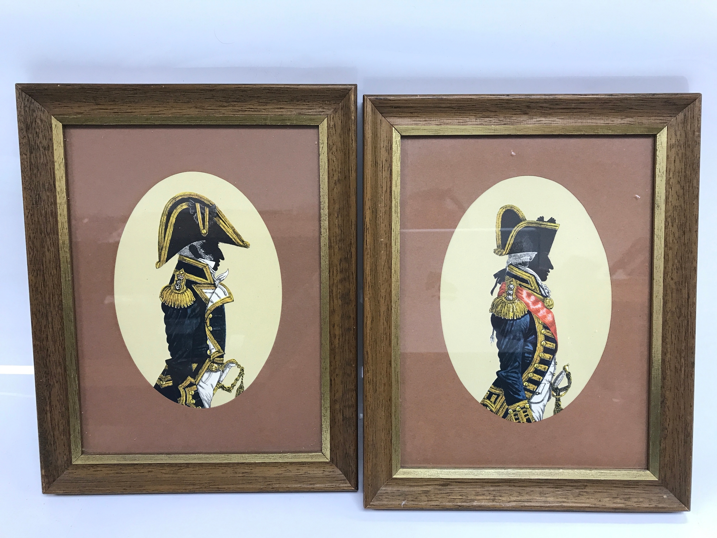 pair of framed vintage reproduction silhouette prints depicting Hugh Evelyn Royal Navy uniforms from the Napoleonic Wars era
