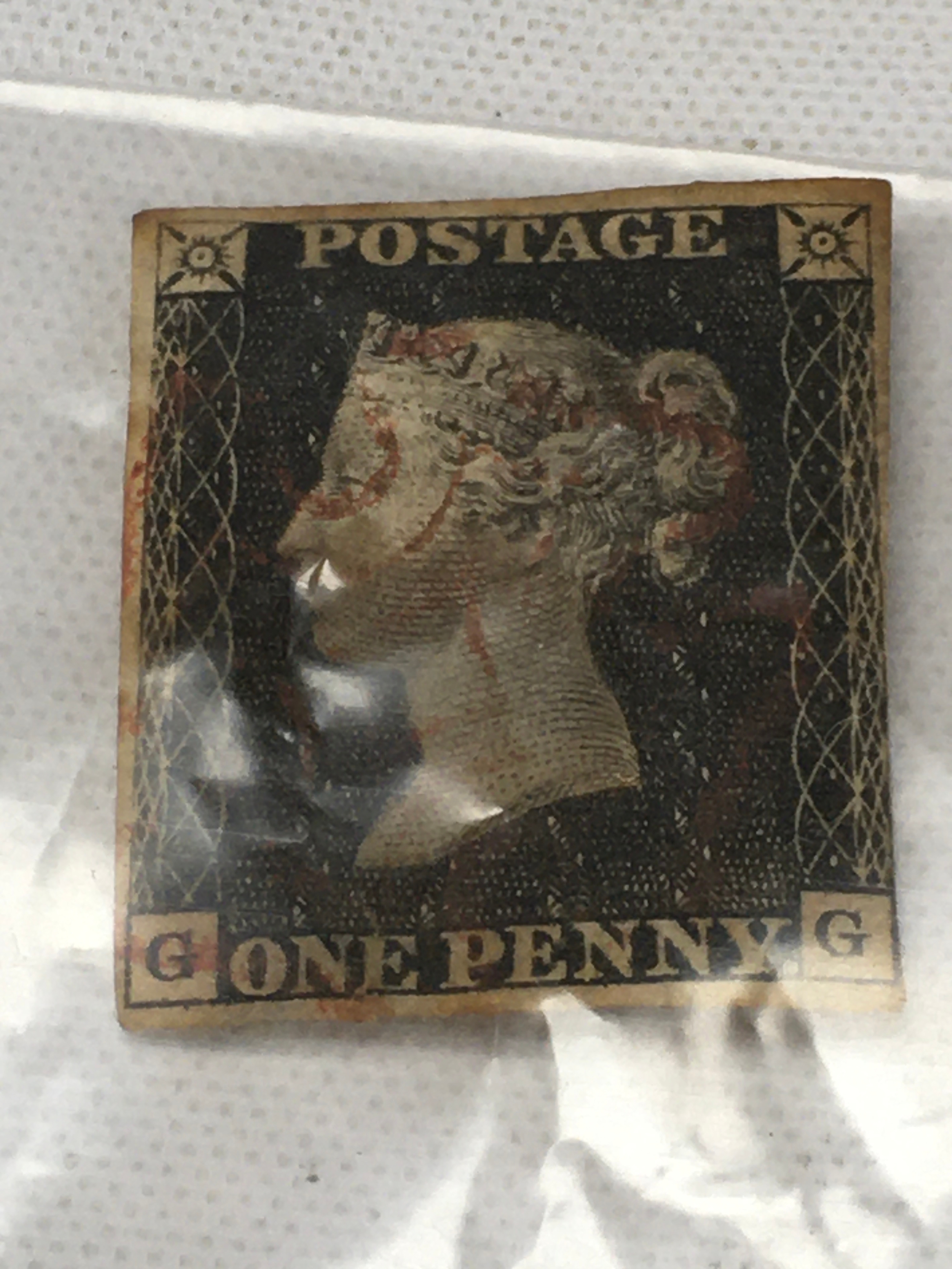 1840s Queen Victoria One Penny Black postage stamp featuring a profile of Queen Victoria and a red Maltese Cross cancellation. G G letters, used. 