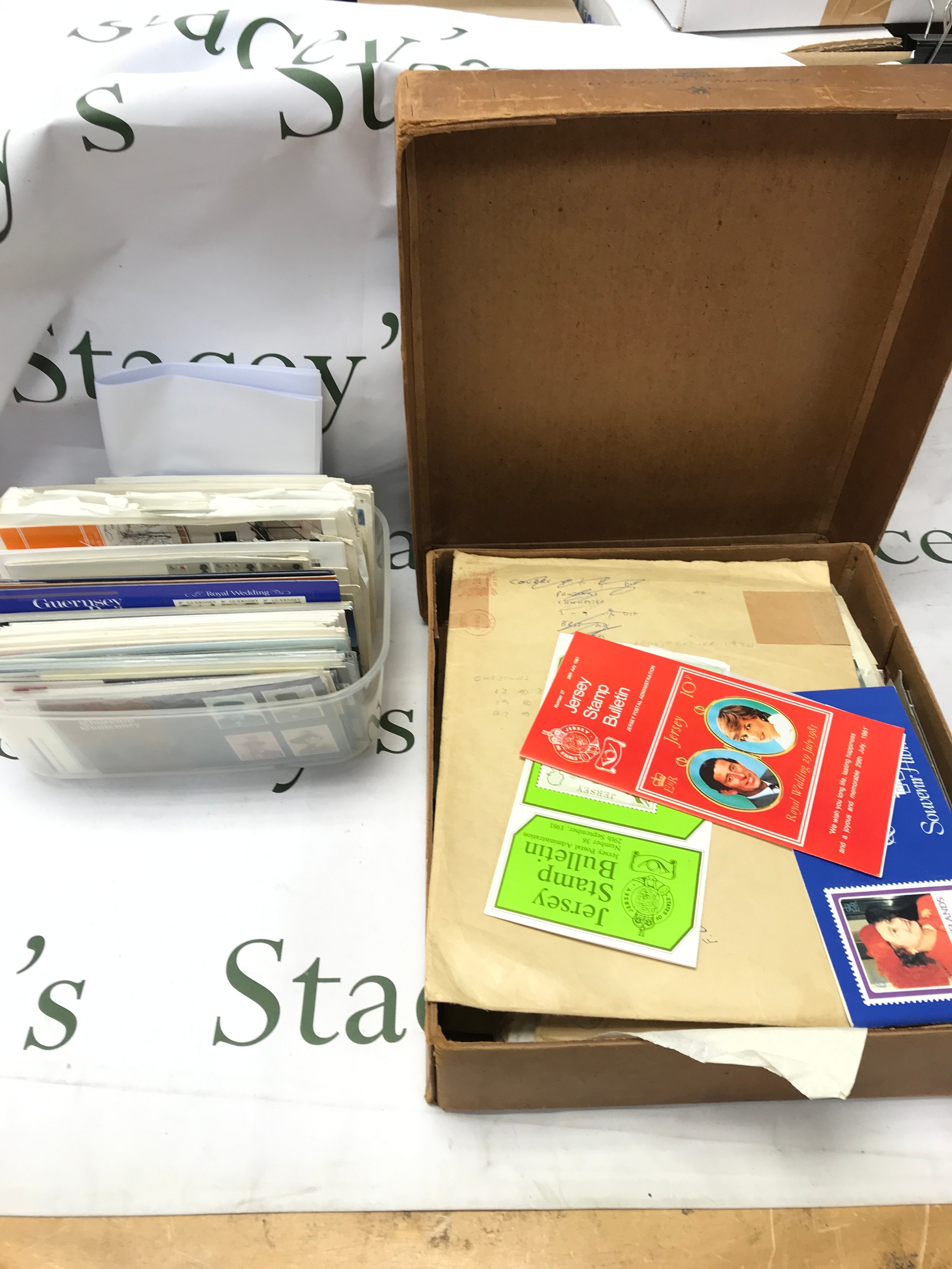 A large collection of stamps mostly Elizabeth II some good unused pre-decimal pictorial sheets, presentation packs Chanel island stamps other world stamps in plastic box x2 and Classic wedding stationary box 