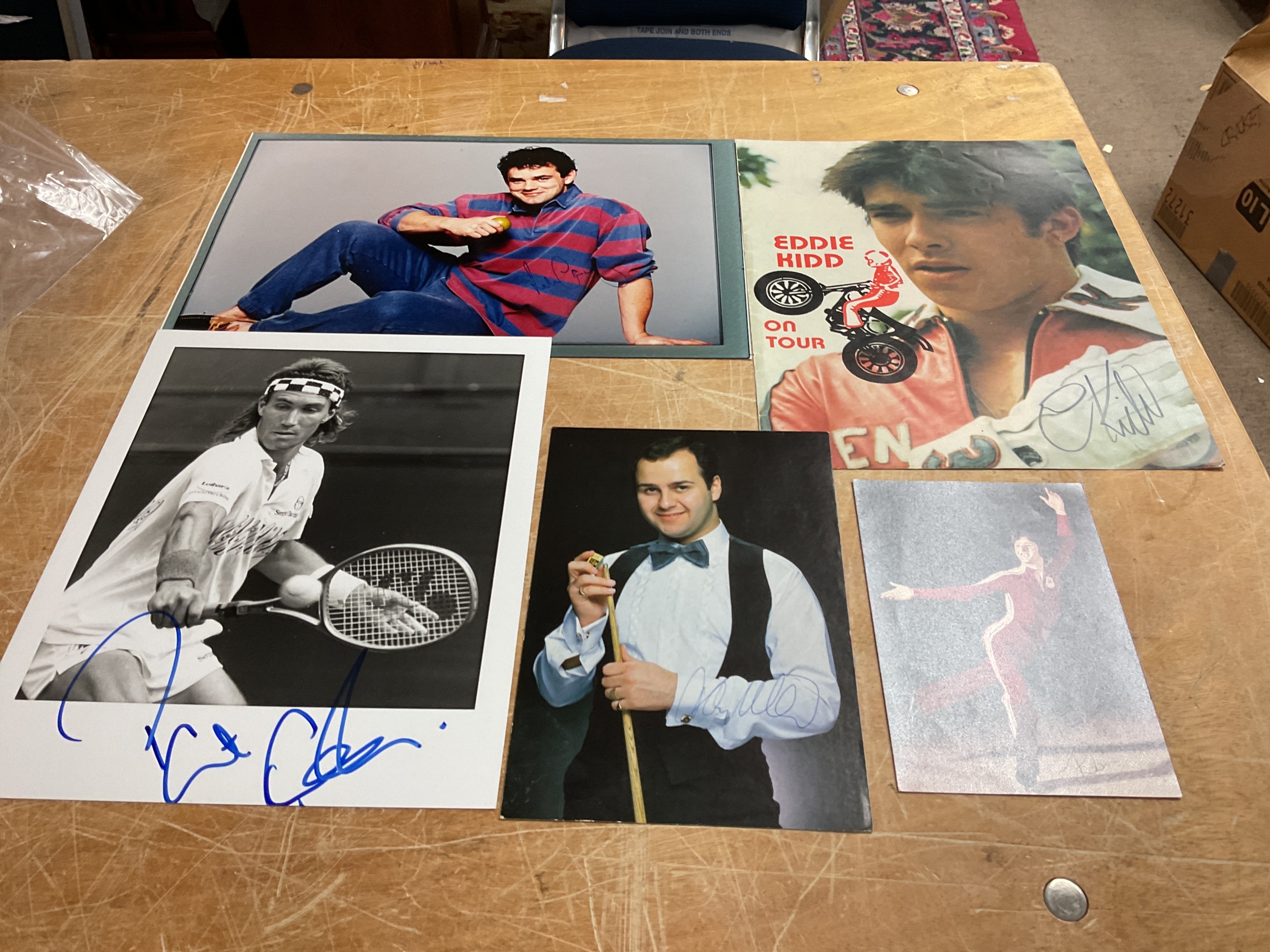 Autographed photos of Eddie Kidd, Robin Cousins, Will Carling, Pat Cash and Tony Meo.