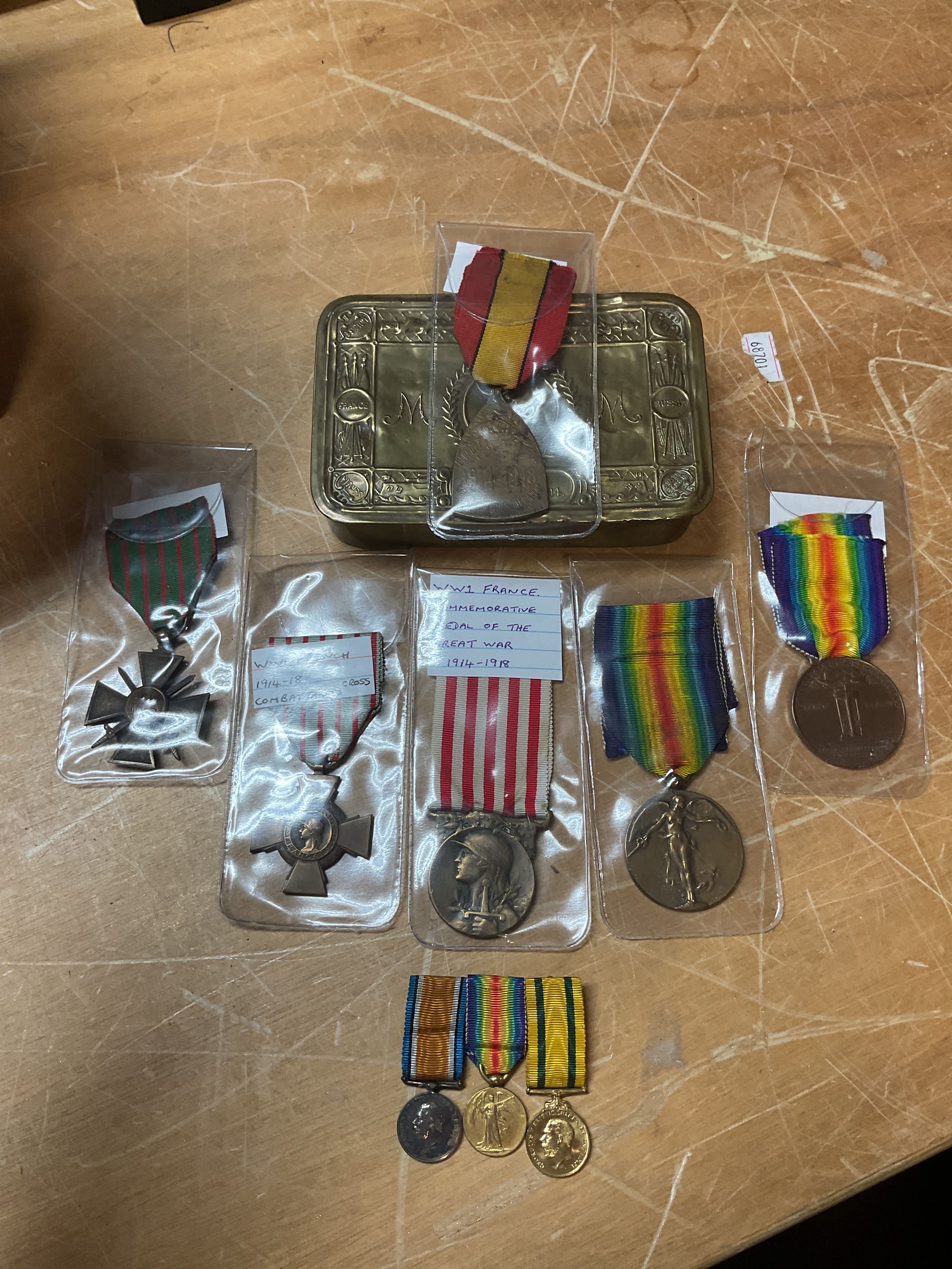 Six mixed French, Belgian and Italian WWI medals, a Queen Mary tin and a miniature set of medals.