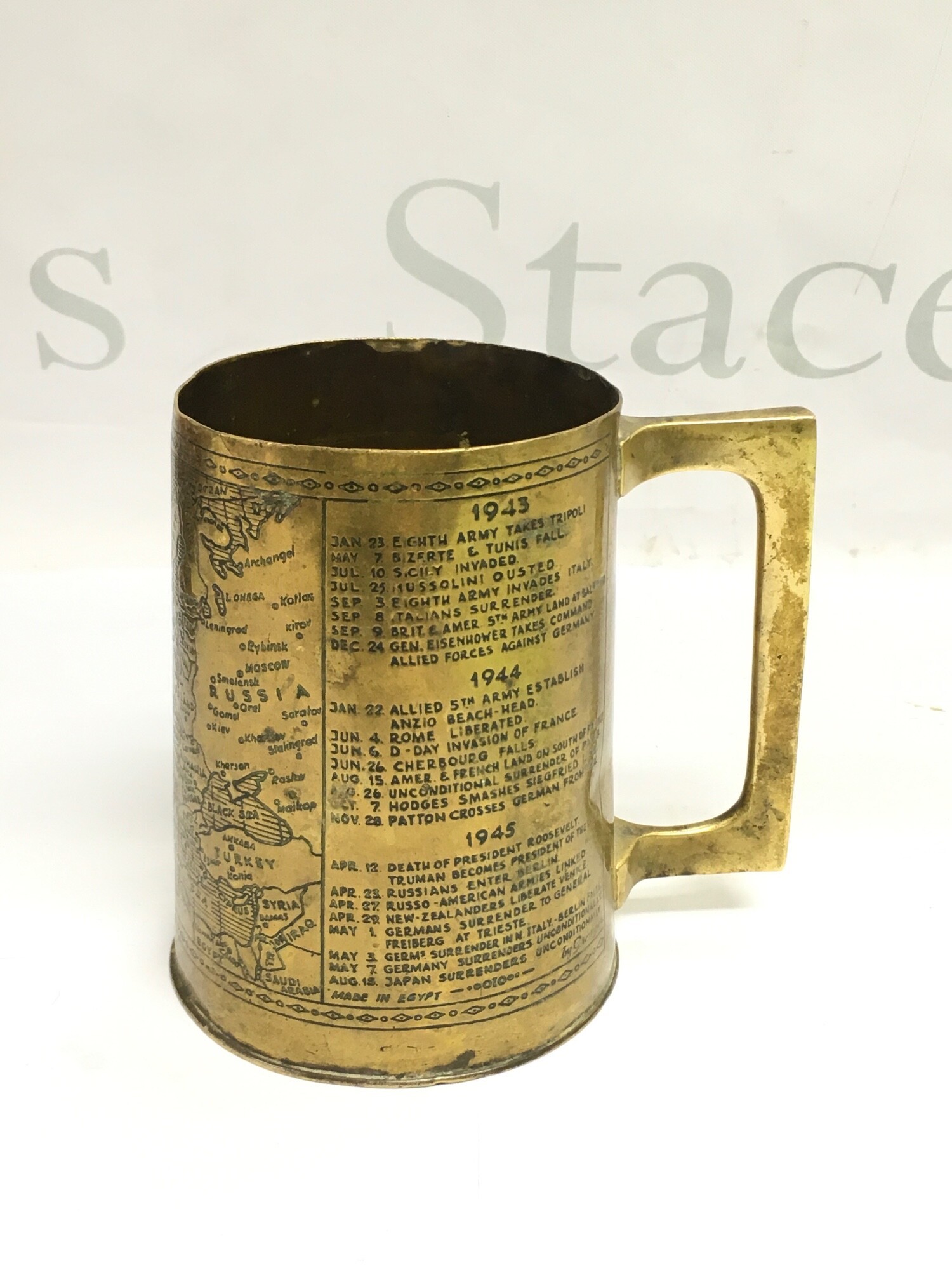 A Trench Art tankard by Granger of Egypt depicting a brief year by year history of WW2, approx height 11.5cm.