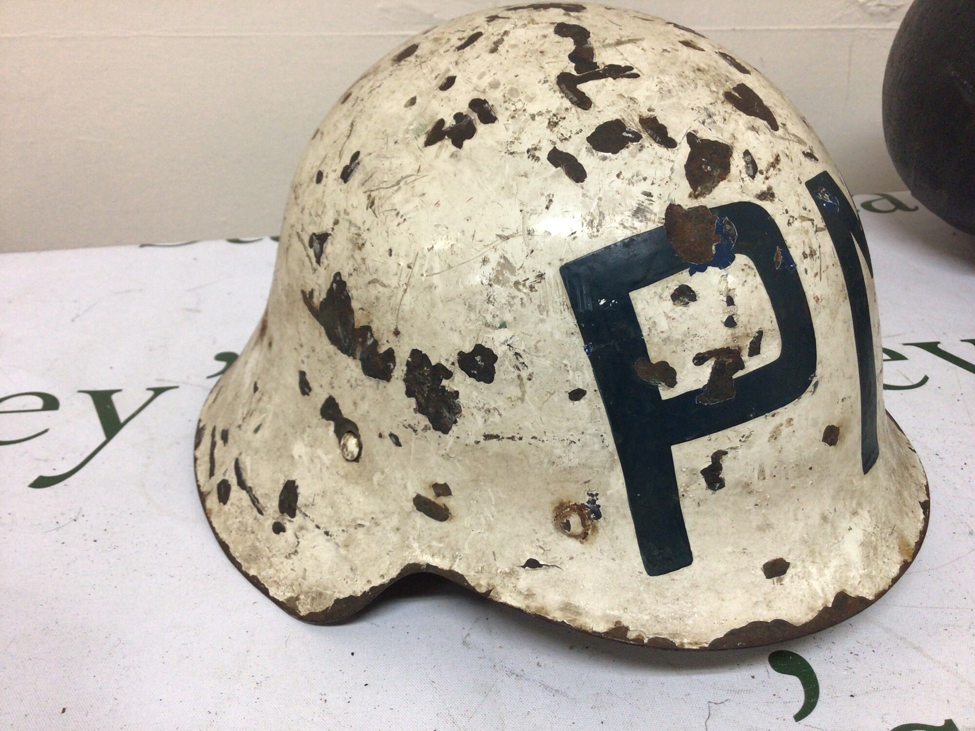 A Spanish Military Police helmet PM on a white ground II world war era. Partially lined.