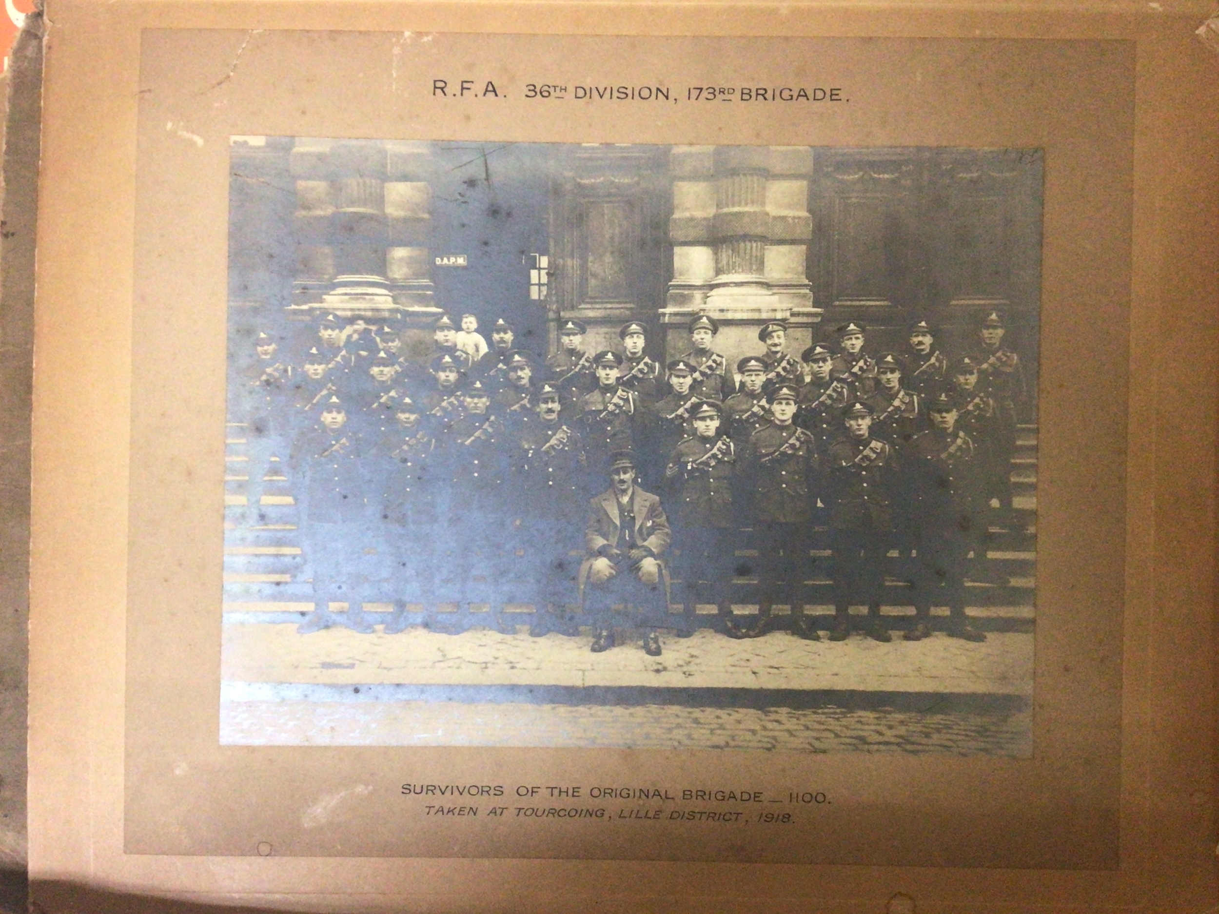 A box containing regimental group photos I world war and others including a photo of the survivors of RFA 36th Division 173rd Brigade British troops in India and others. A map and signed Allo Allo 1980s photo. 