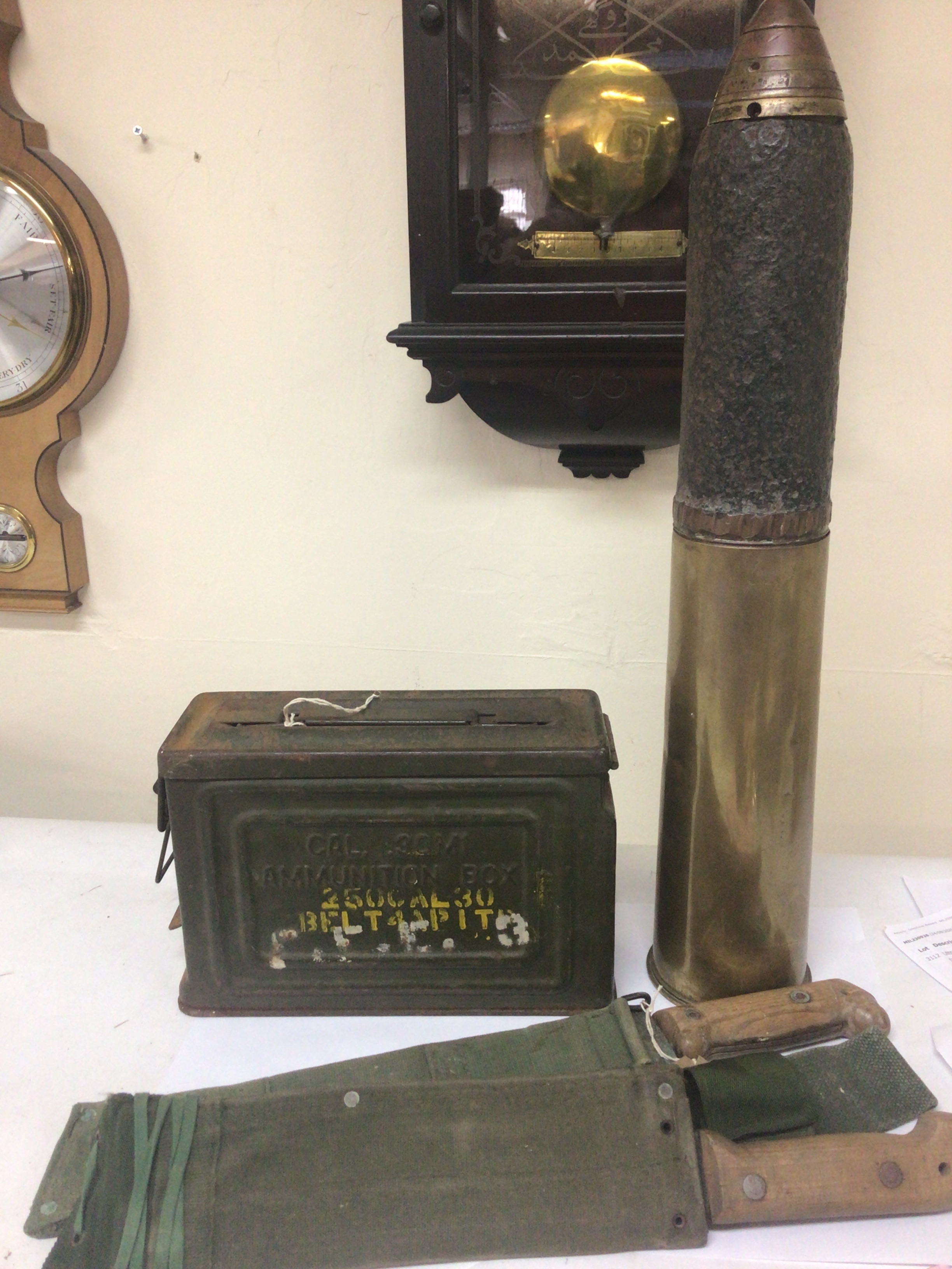  A military ammunition box .30M1 a deactivated shell case and two military issue machetes (4) 