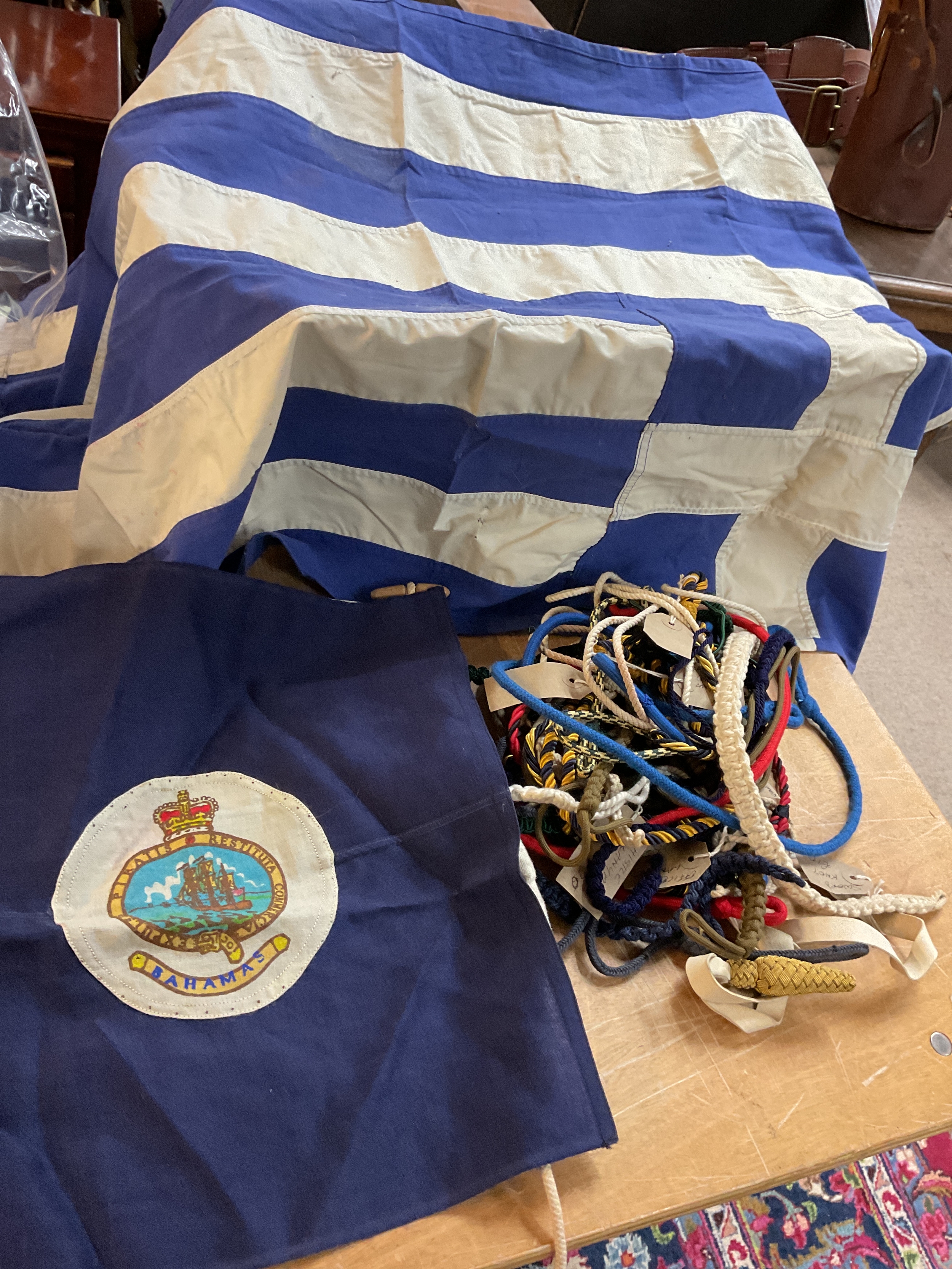 Qty of military lanyards and Greek and Bahamian flag.