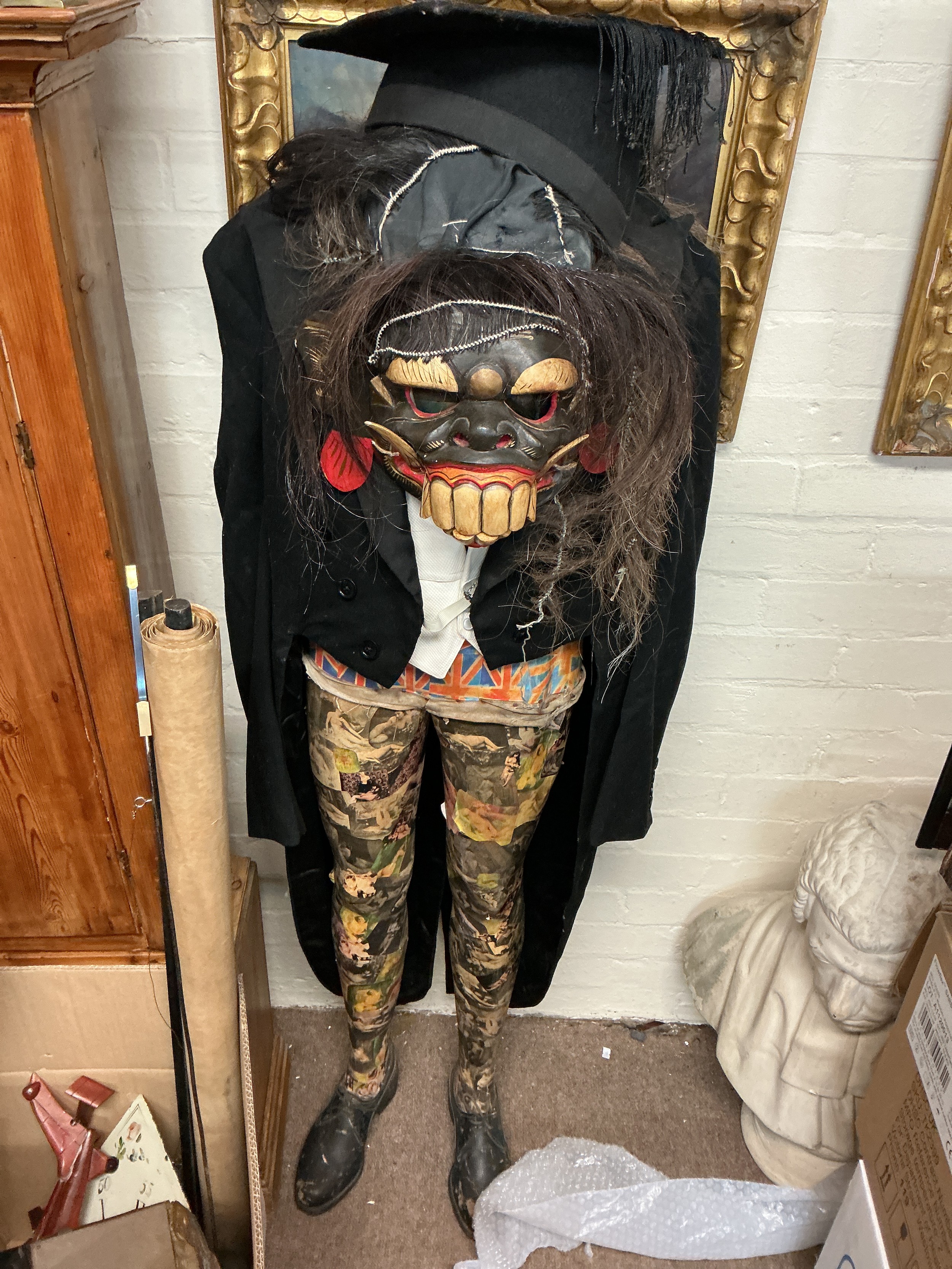 A figure sculpture 20th century with a grotesque mask.