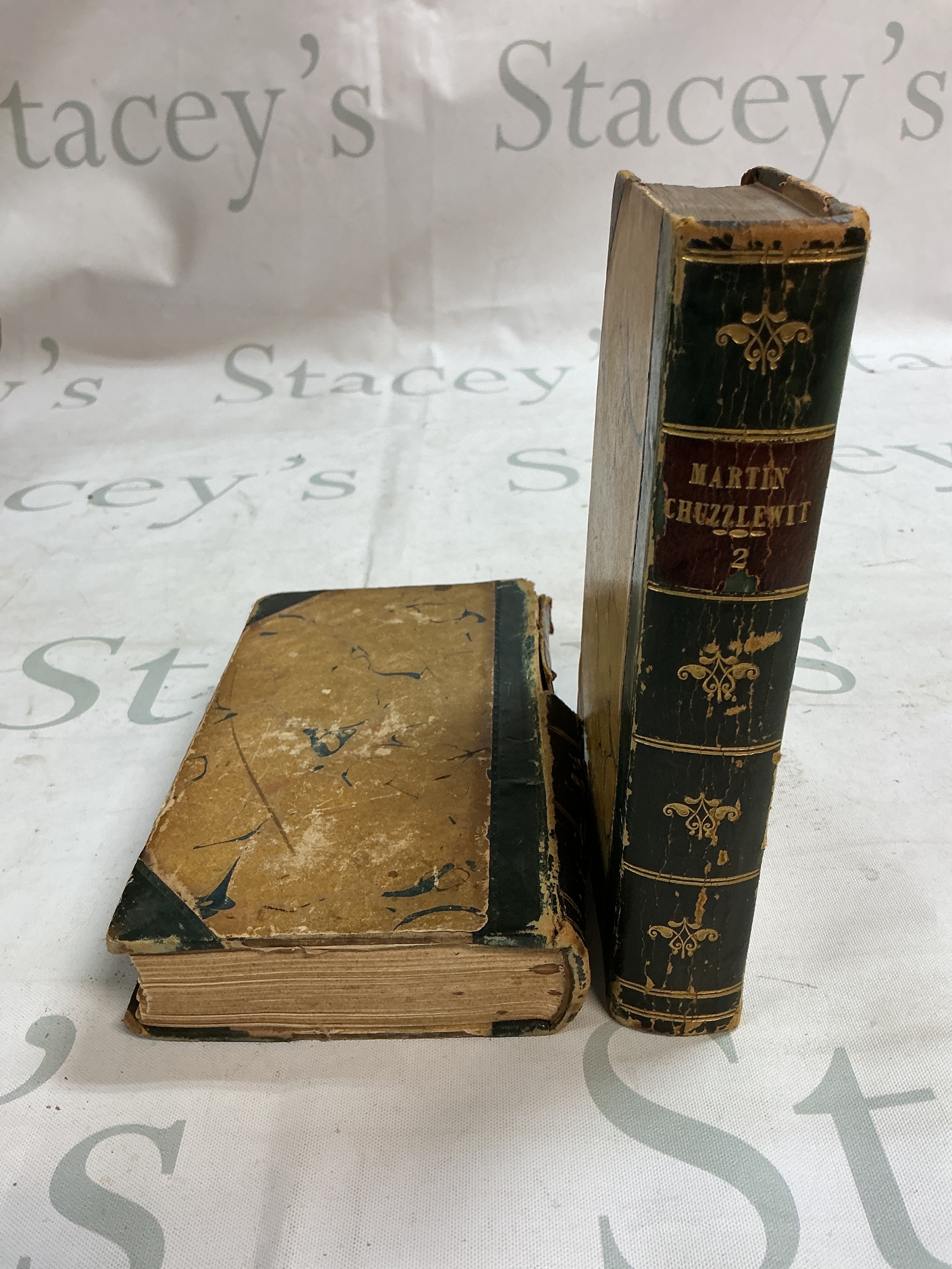 Two antique volumes of The Life and Adventures of Martin Chuzzlewit by Charles Dickens. 