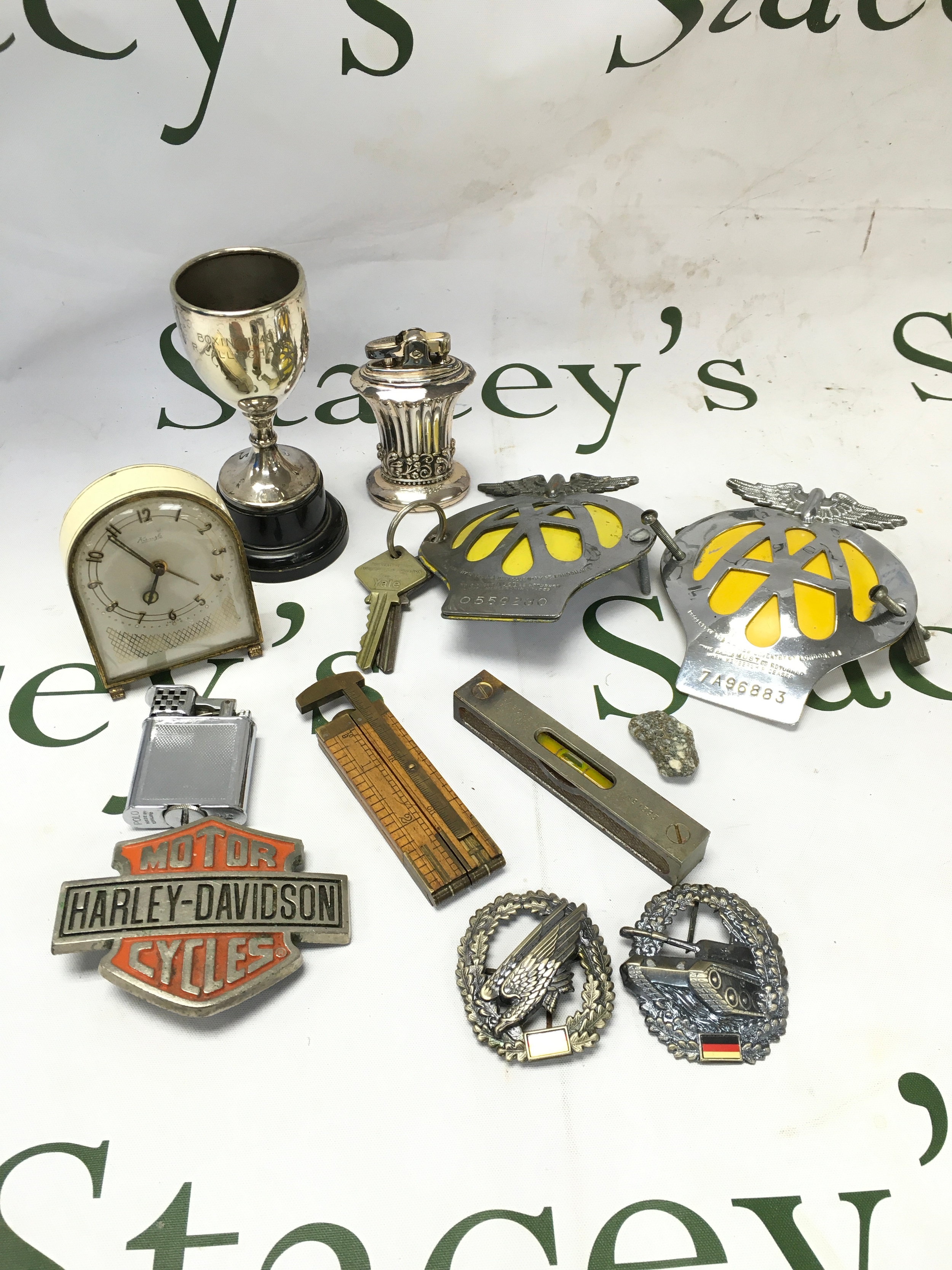 A collection of vintage items including two AA badges, small rule, lighters, badges, miniature clock 