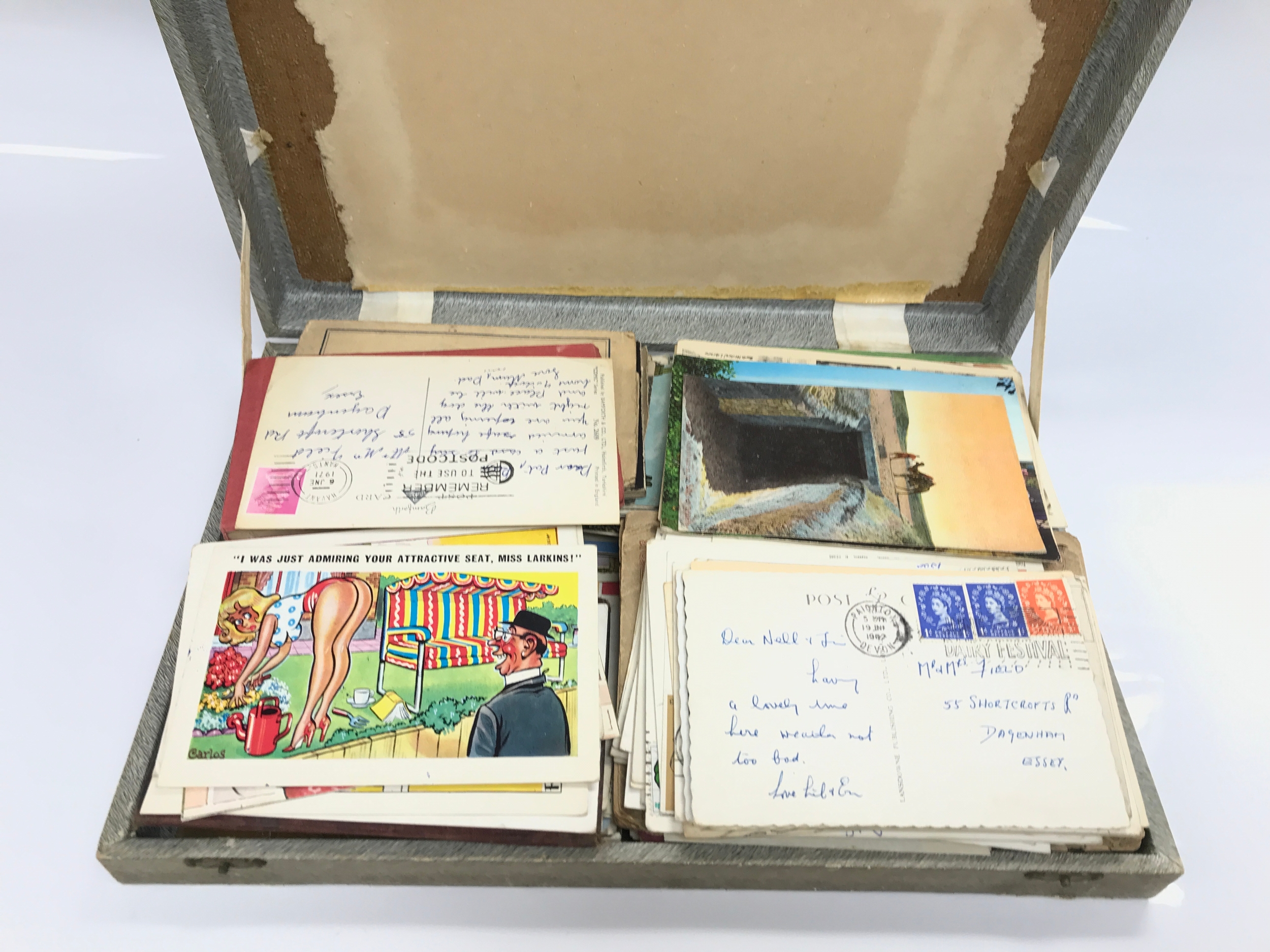 A box containing vintage postcards
