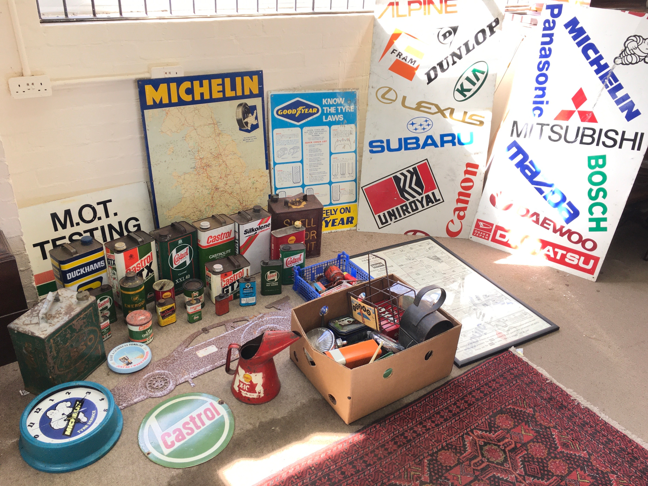 A quantity of vintage Automobile enamel signs, oil cans, tins etc. Including Michelin, Castrol etc