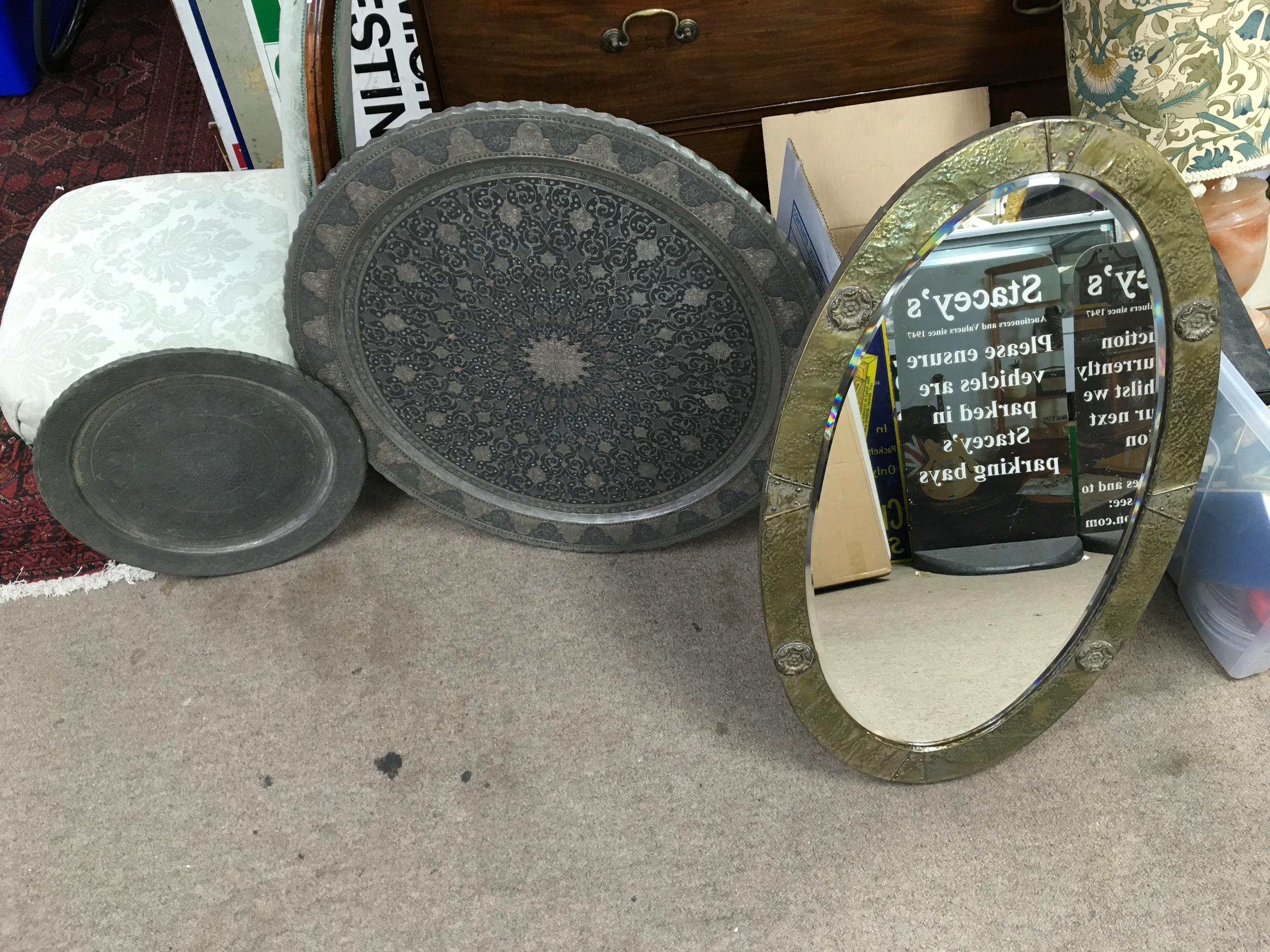 Vintage Middle Eastern or Persian hand-engraved metal tray, likely made of tinned copper or brass featuring traditional intricate floral and geometric motifs and a metal clad mirror 
