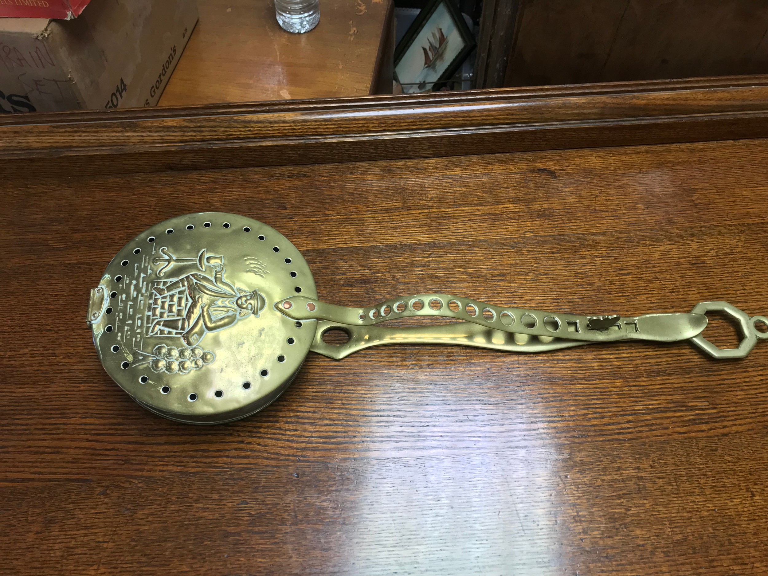 A brass chestnut warming pan.  57cm long