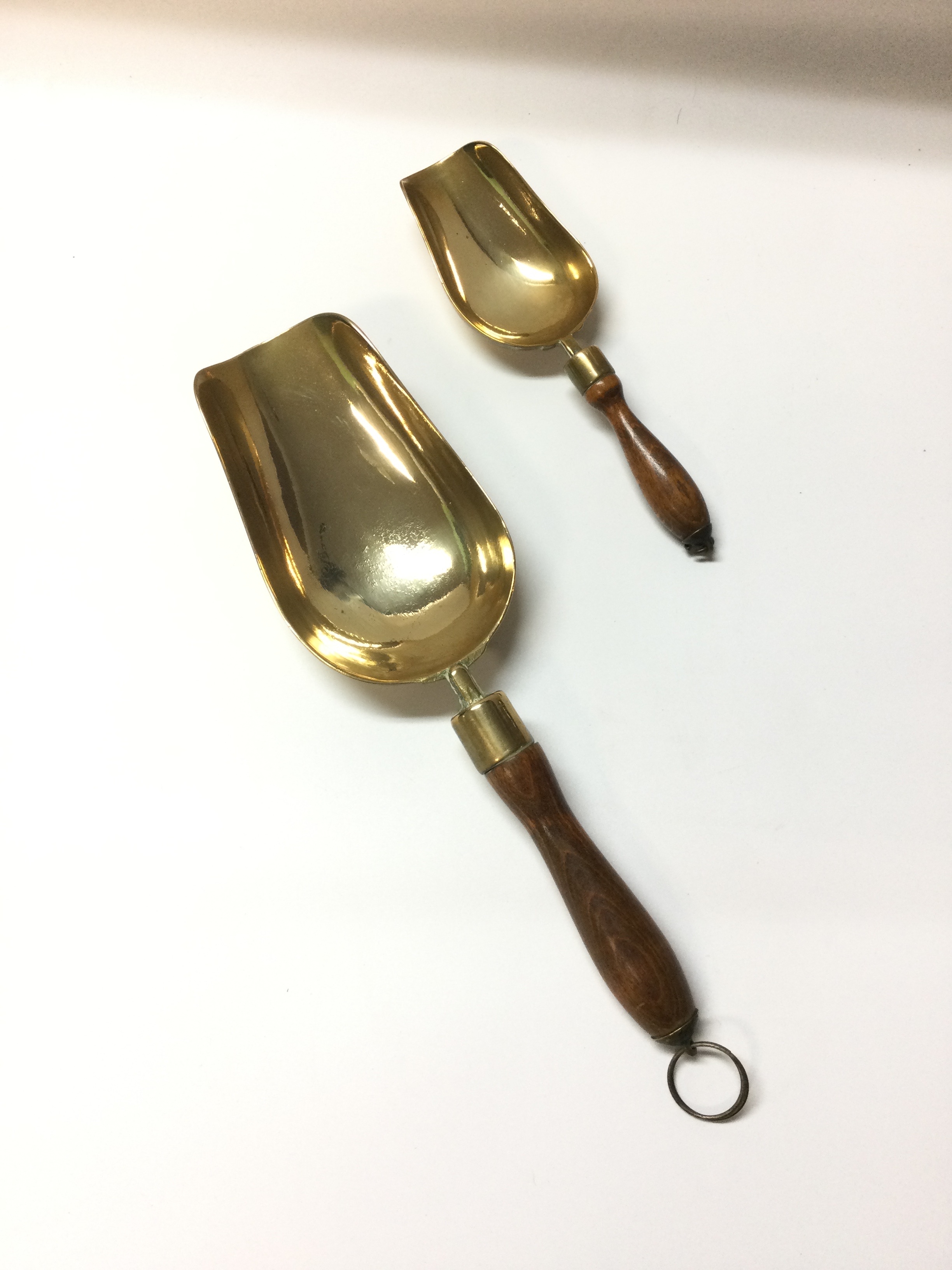2 vintage brass scoops with a turned wooden handle 