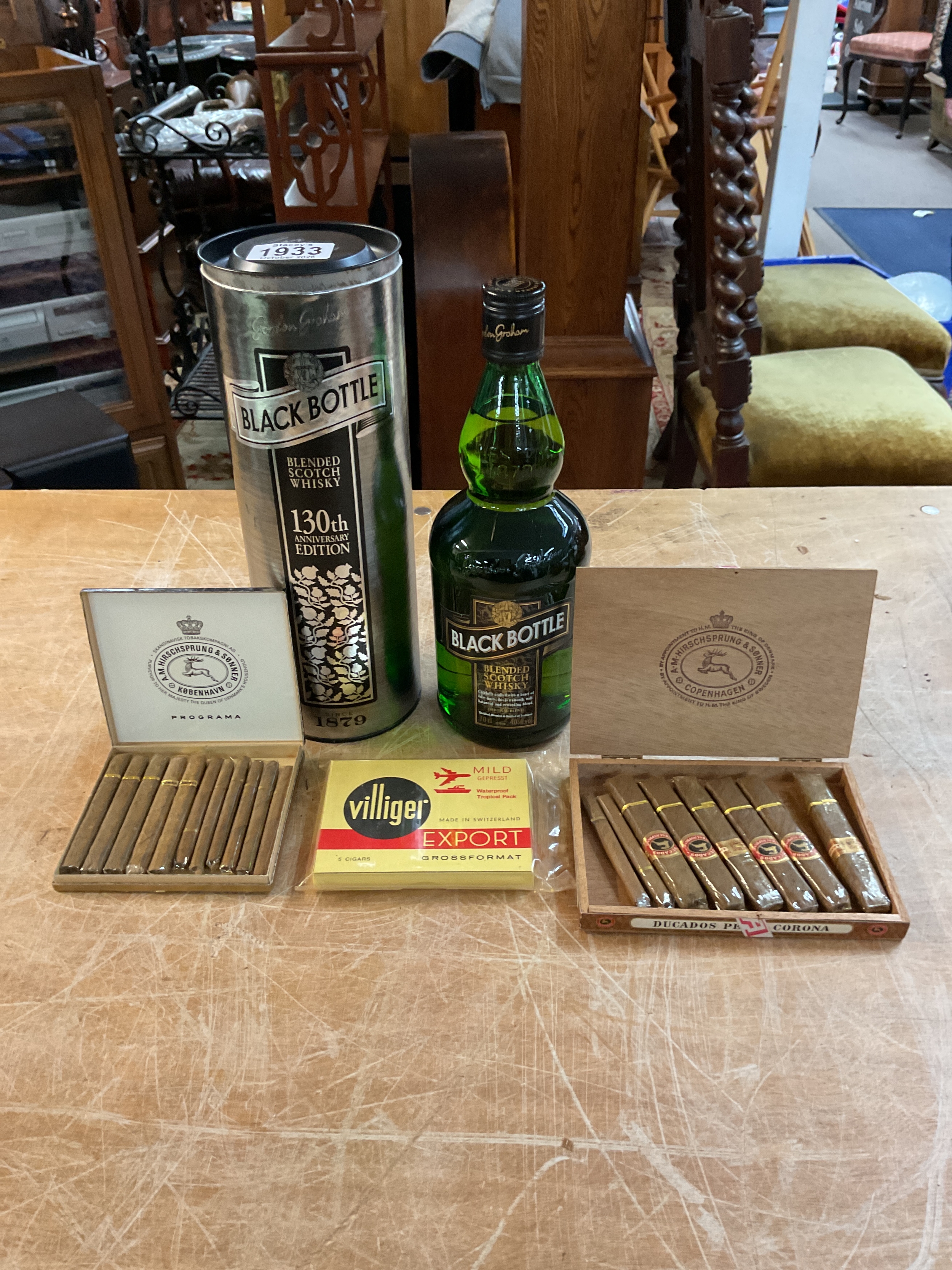Black Bottle Whisky and three boxes of cigars.