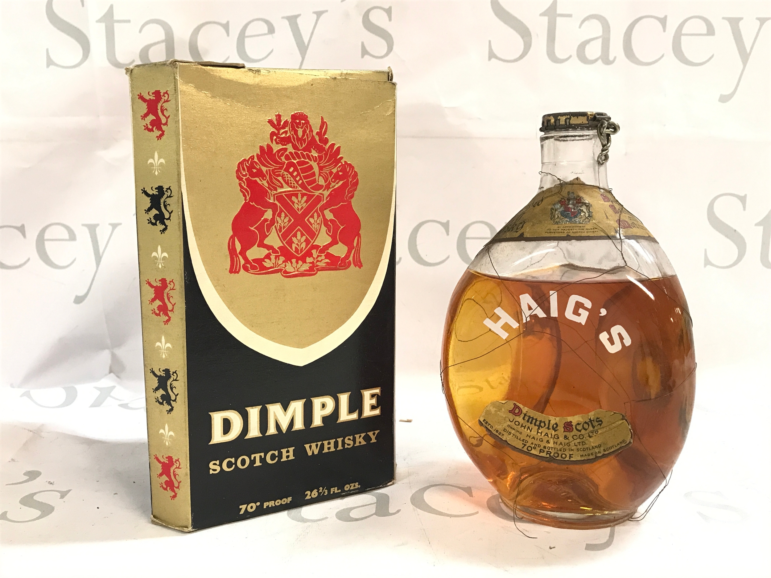 A bottle of boxed vintage Dimple scotch whiskey and a bottle of Haigs