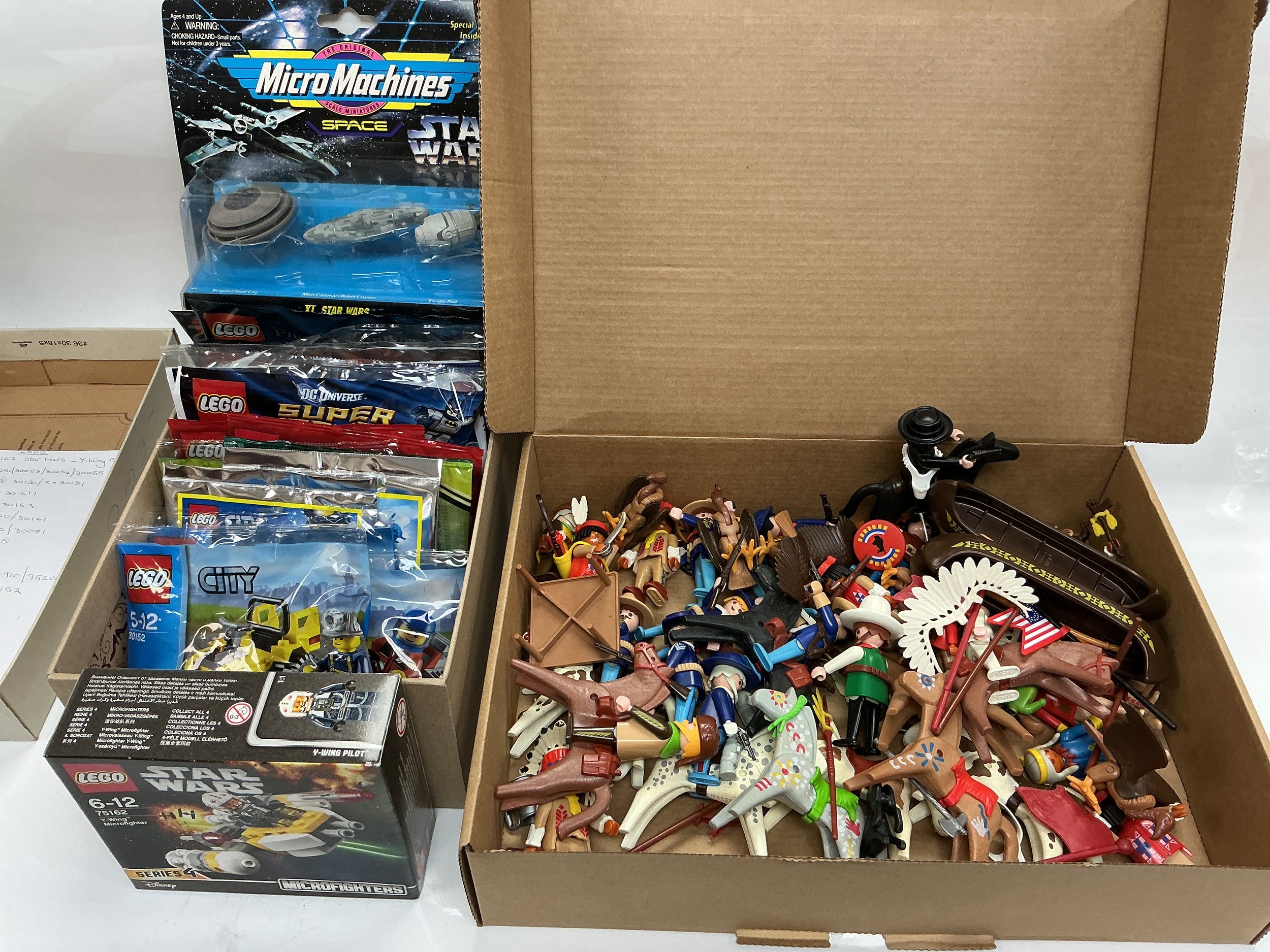 A collection of Lego mini sets, a Playmobil Wild West playset, figures and accessories.