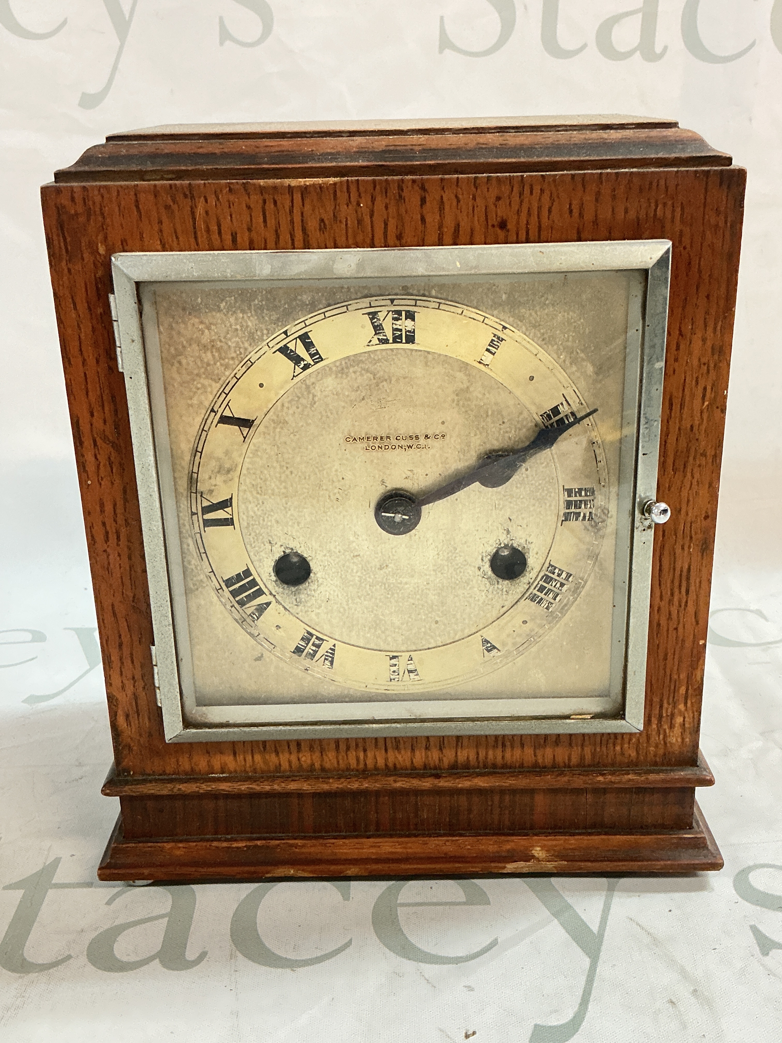 A Camerer Cuss & Co London clock. 21cm tall 18cm wide 