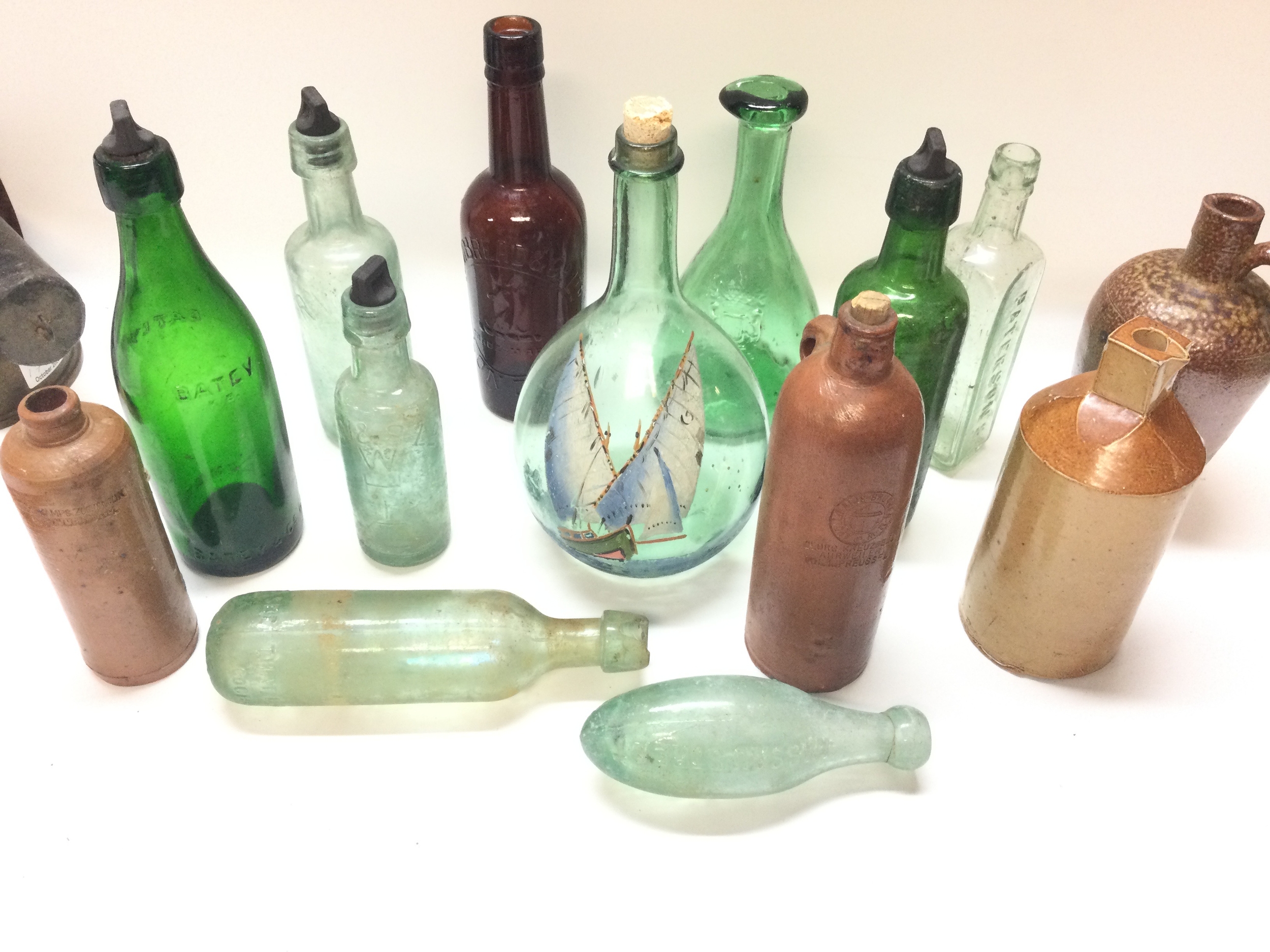 Collection of glassware and stoneware bottles
