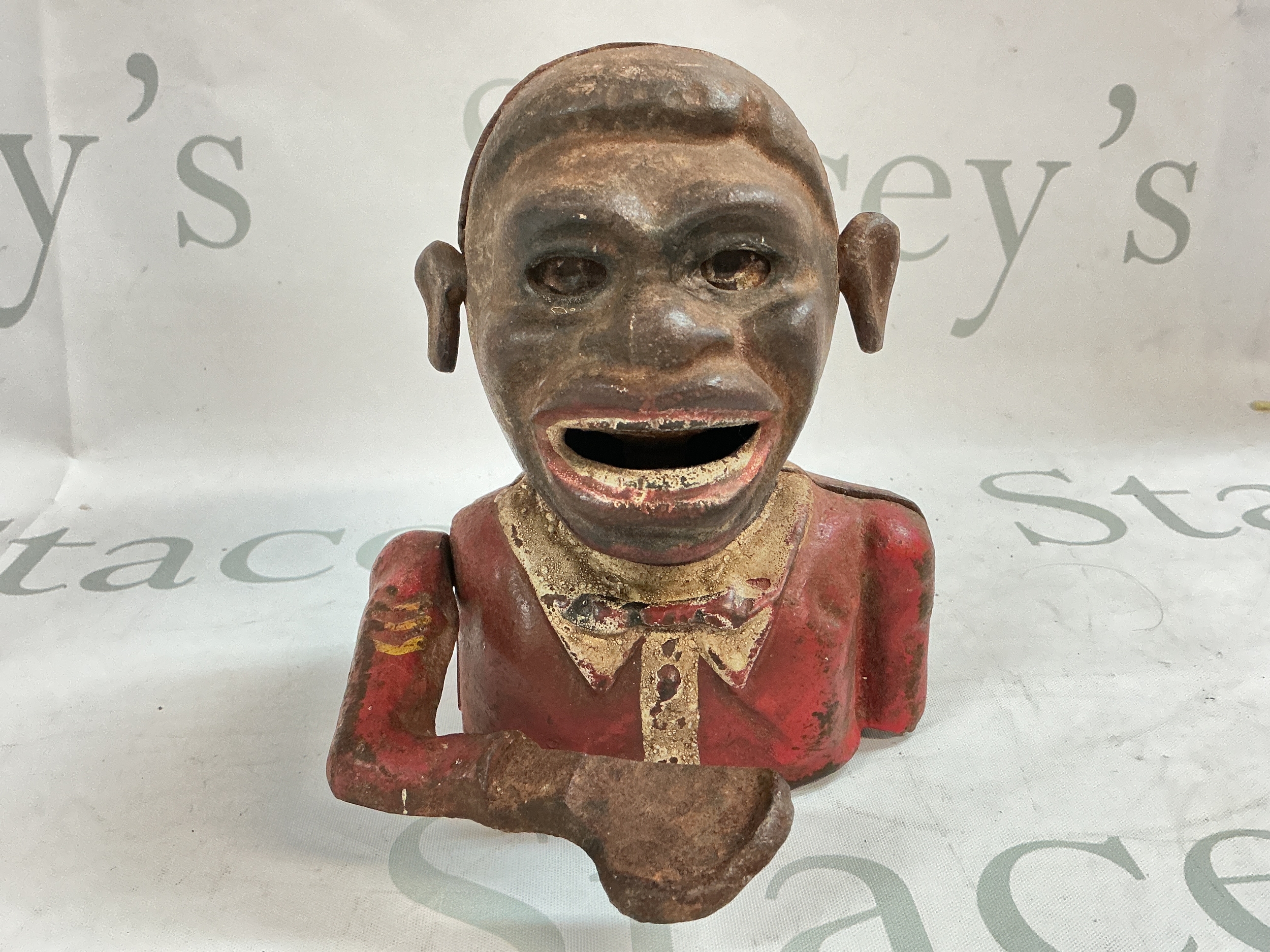 A vintage Jolly cast iron money box. 15 cm tall 