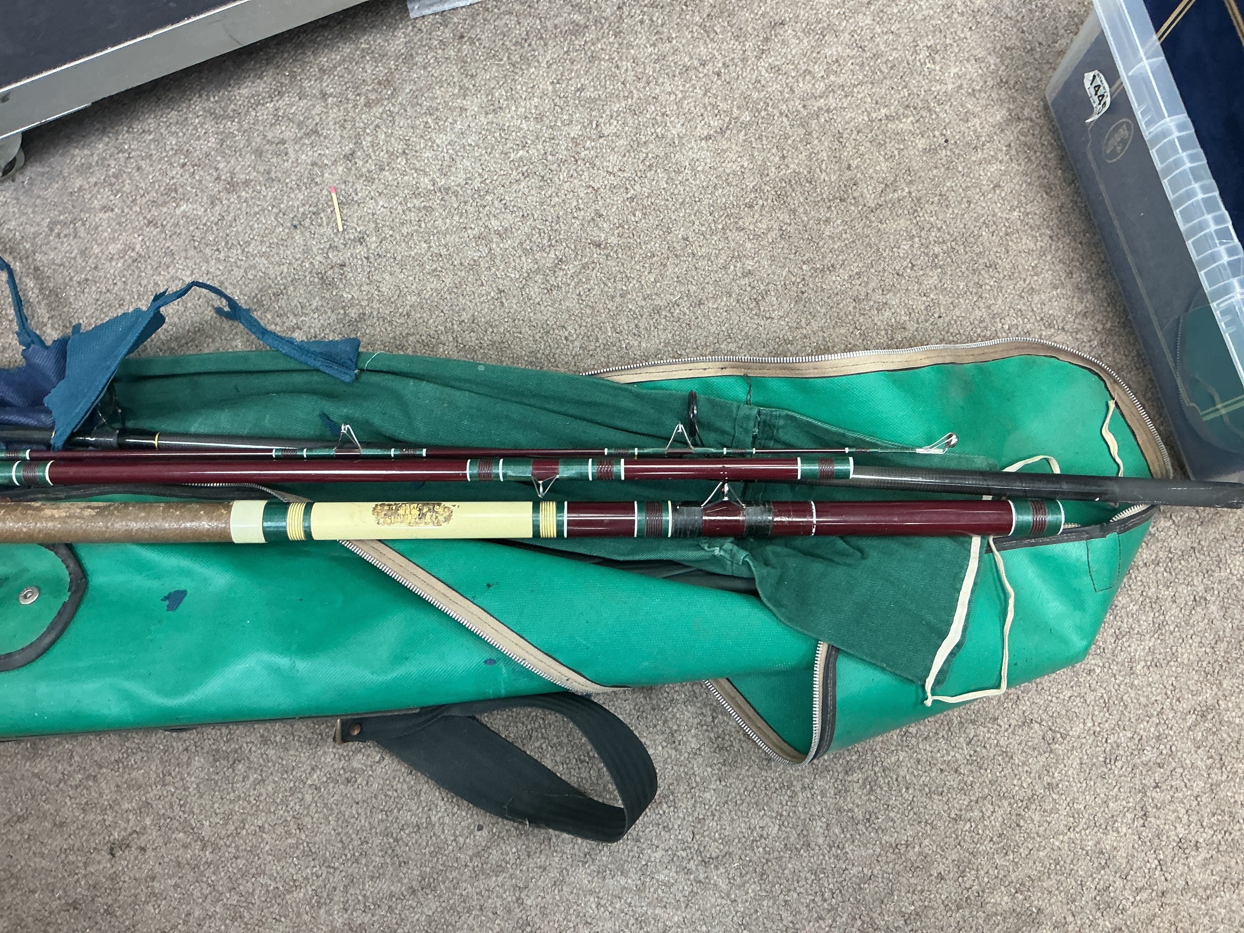 A collection of fishing rods etc.