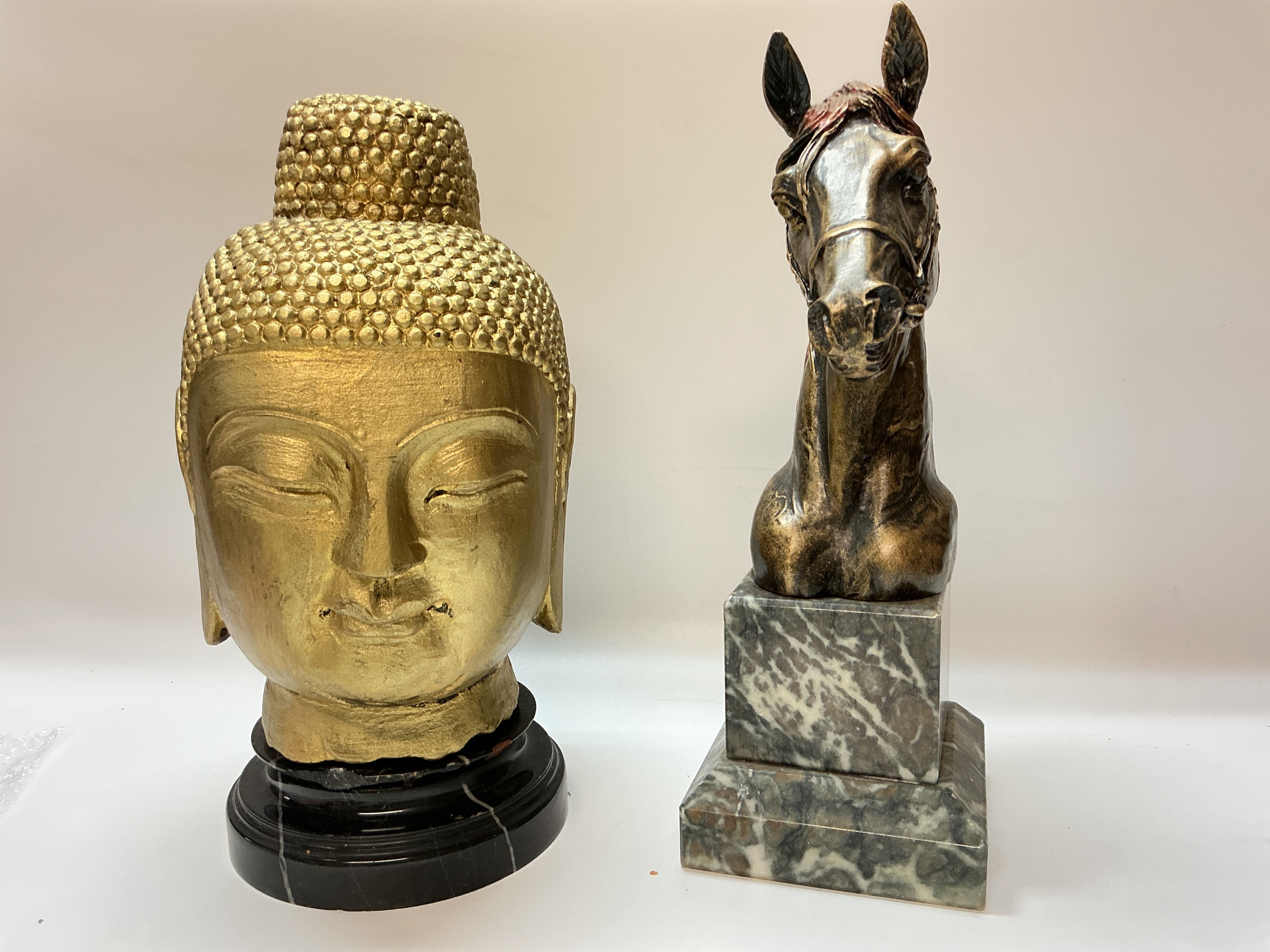 A Buddha head bust and a horse bust 32cm tall