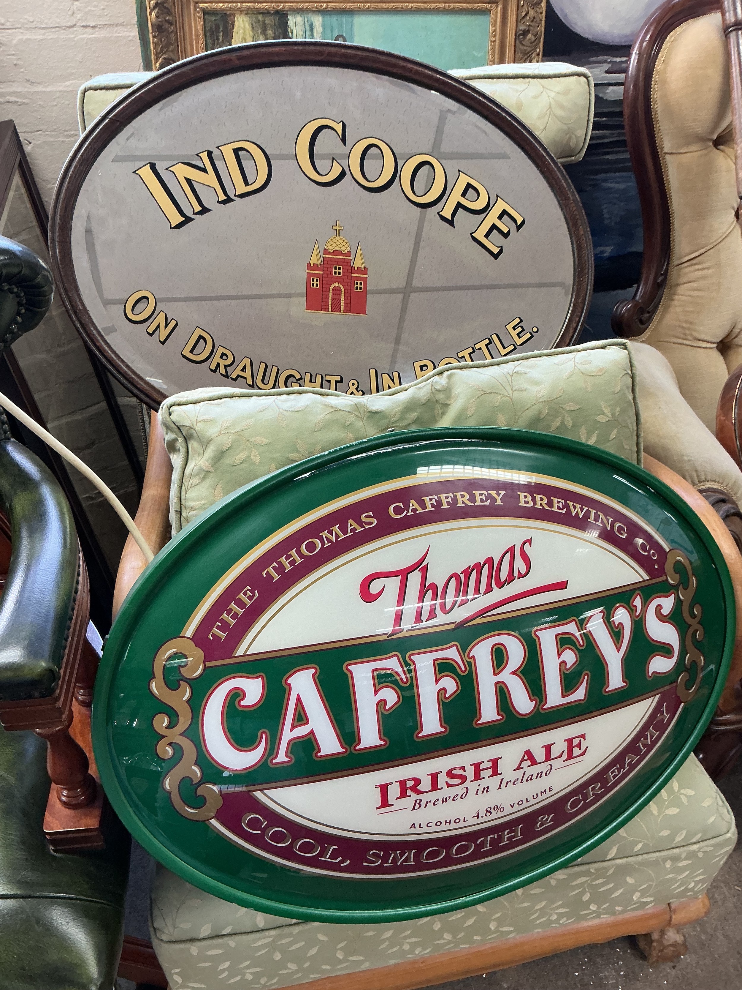 A collection of breweriana items comprising a Caffreys illuminated sign, Ind Coope mirror etc.