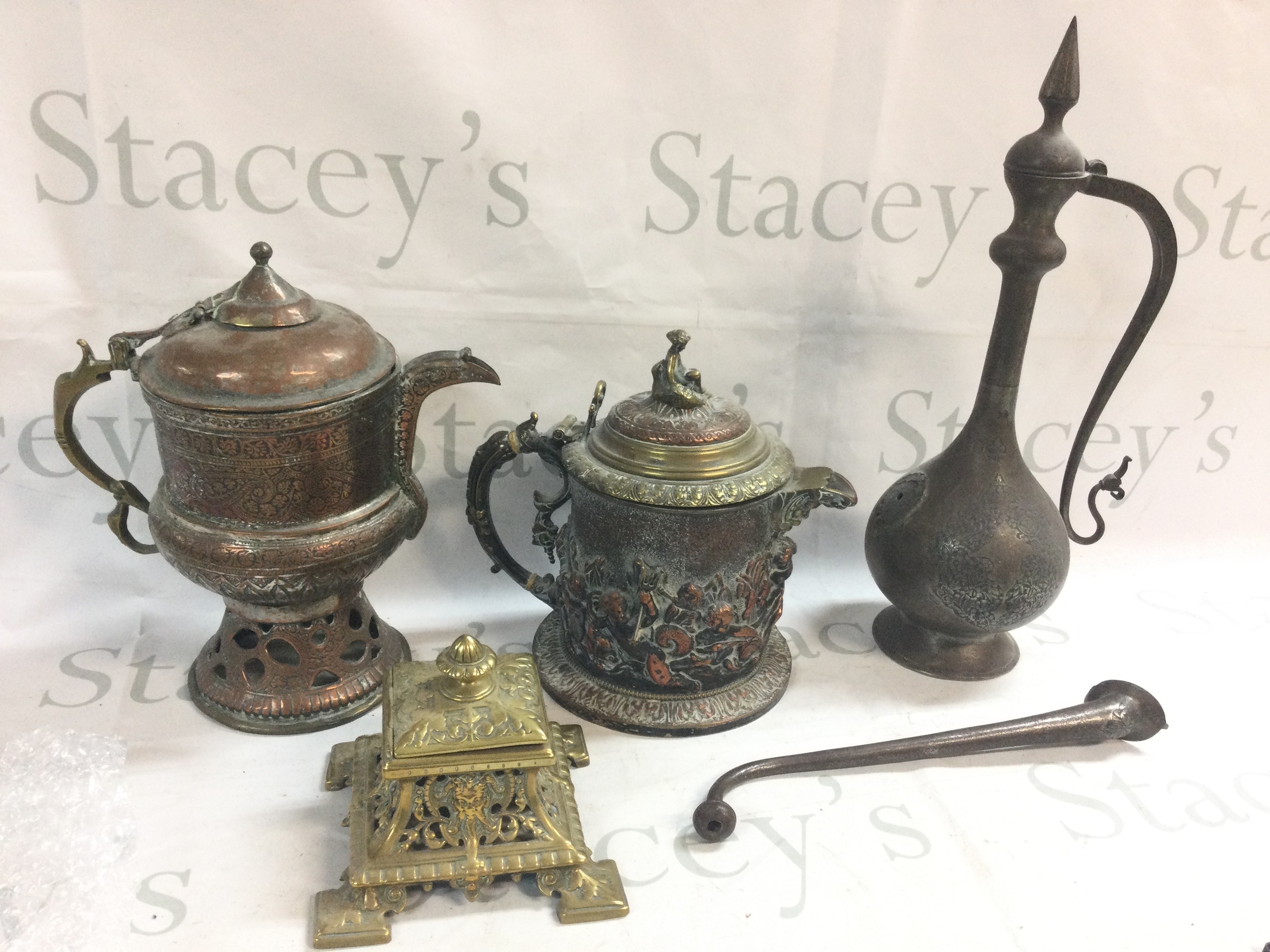 A box of metal ware including jugs, inkwell 