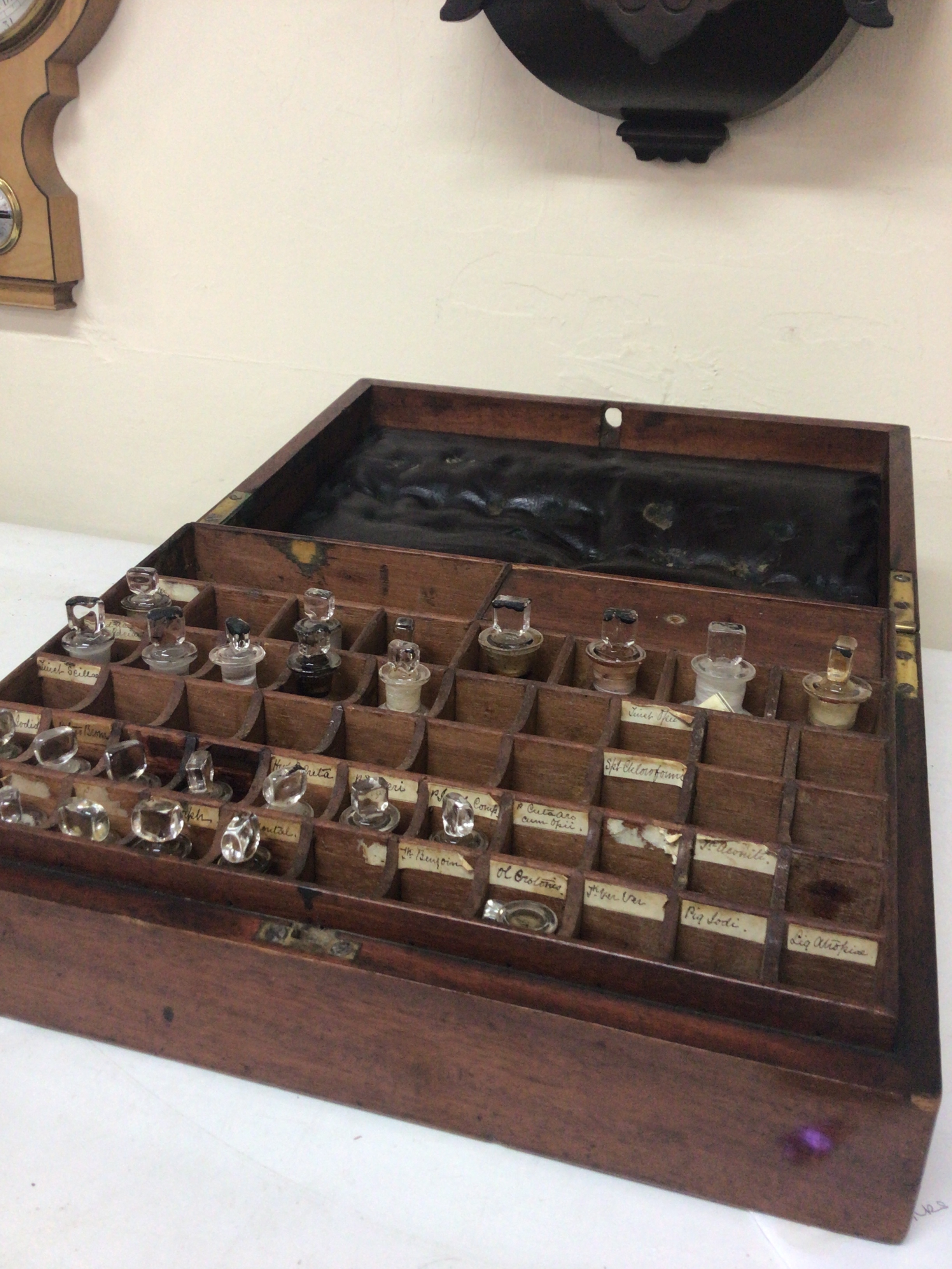 A 19th century mahogany apothecary case with a fitted interior containing glass bottles.