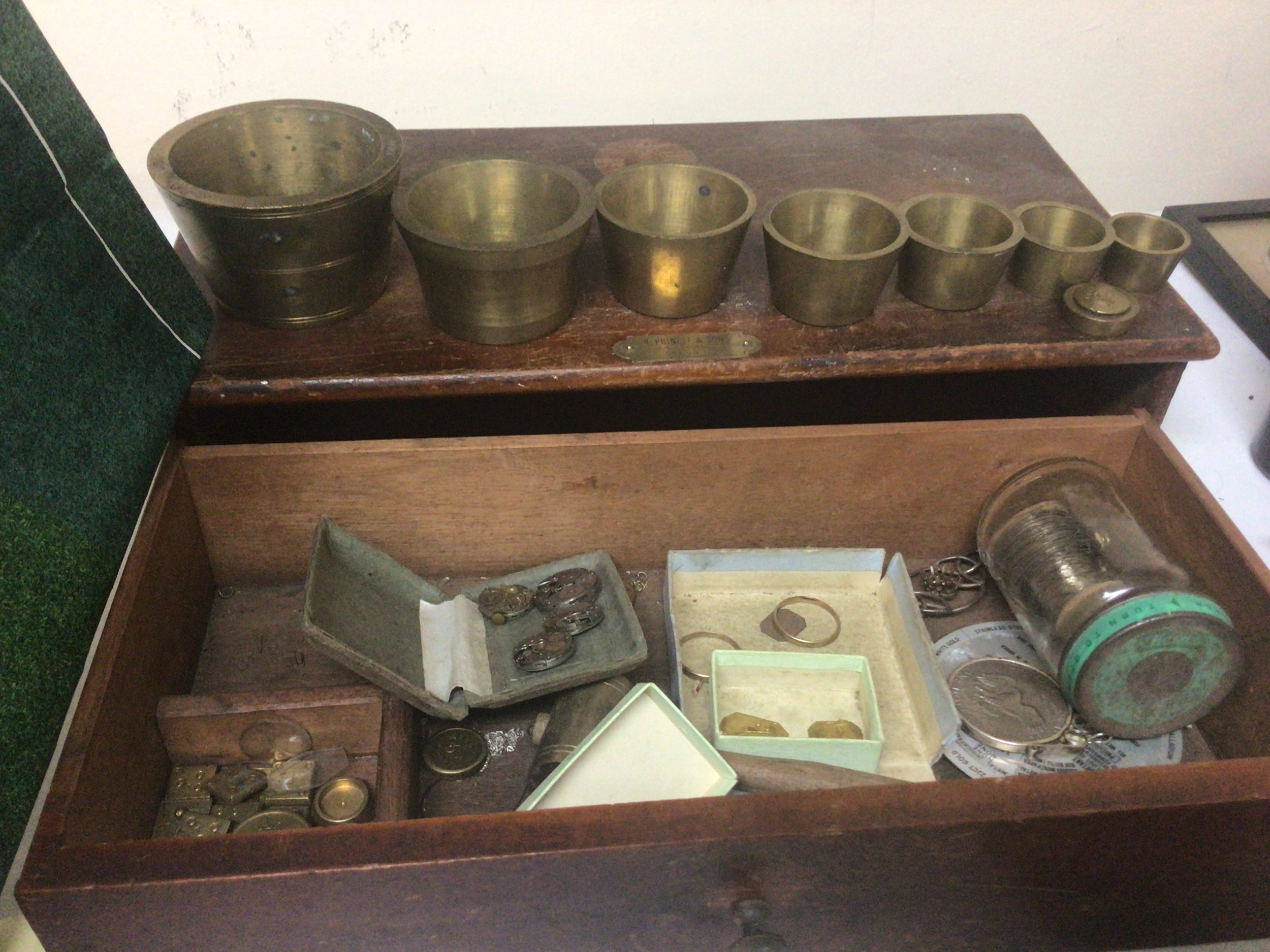 A set of graduating Troy brass weight vessels smaller weights other oddments including the beam balance scales.