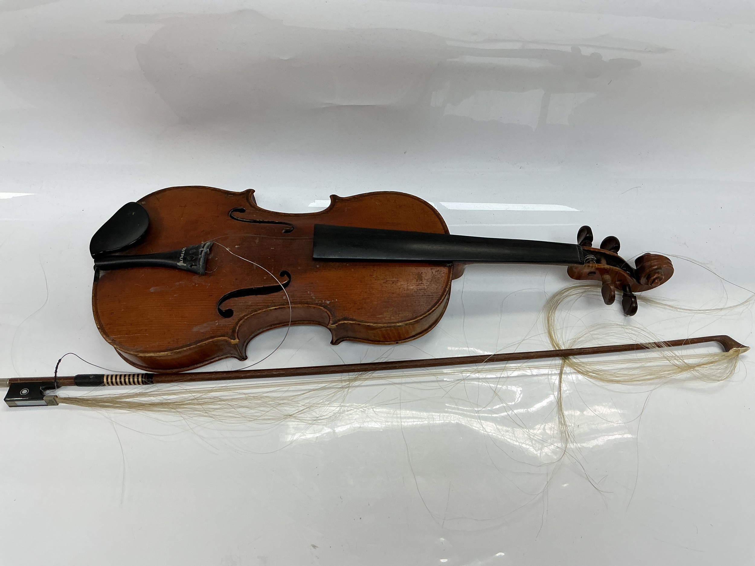 A violin and bow. No label inside soundhole.
