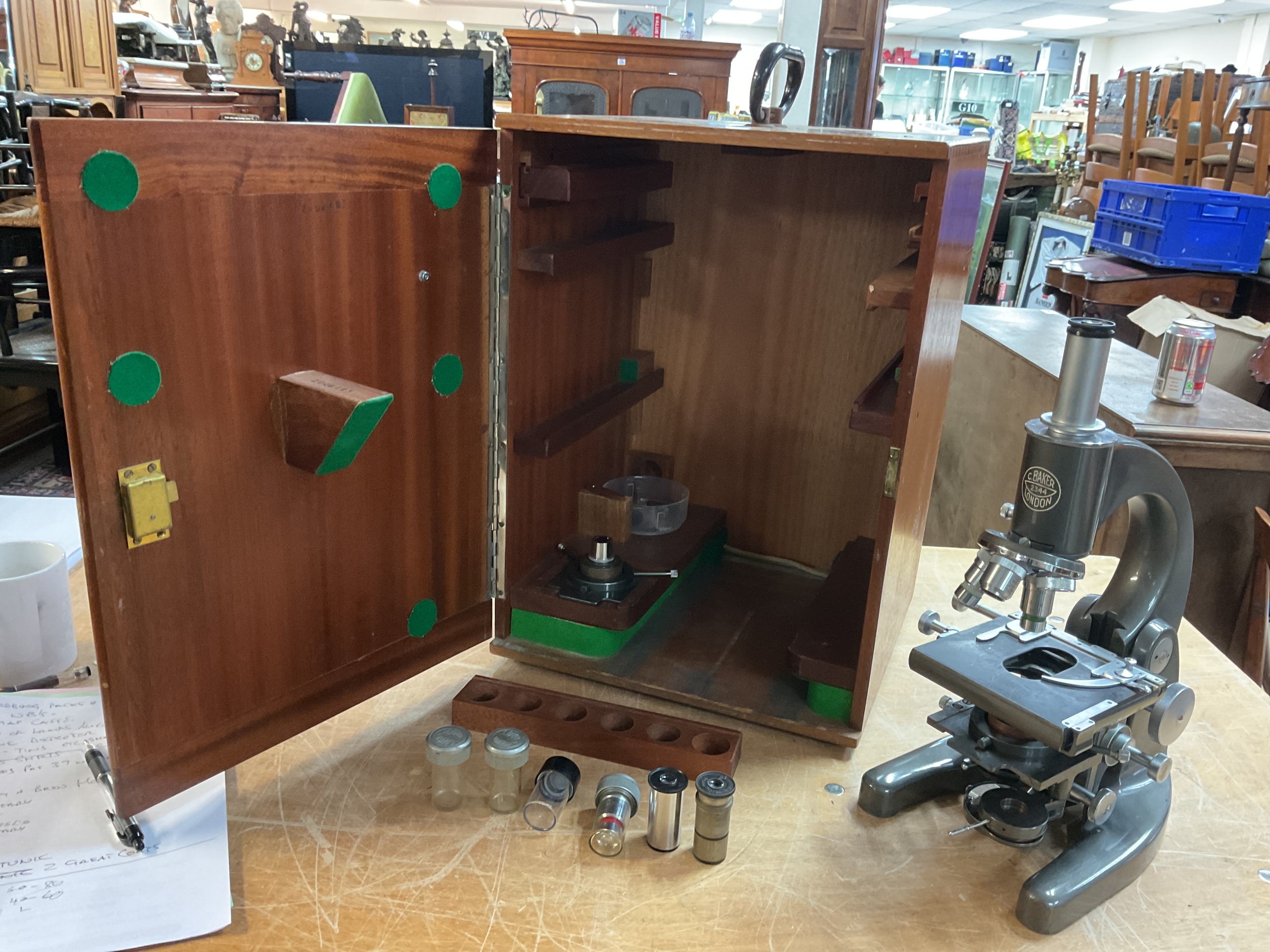 Large boxed C Baker microscope model 2344 with extra lenses and covers.