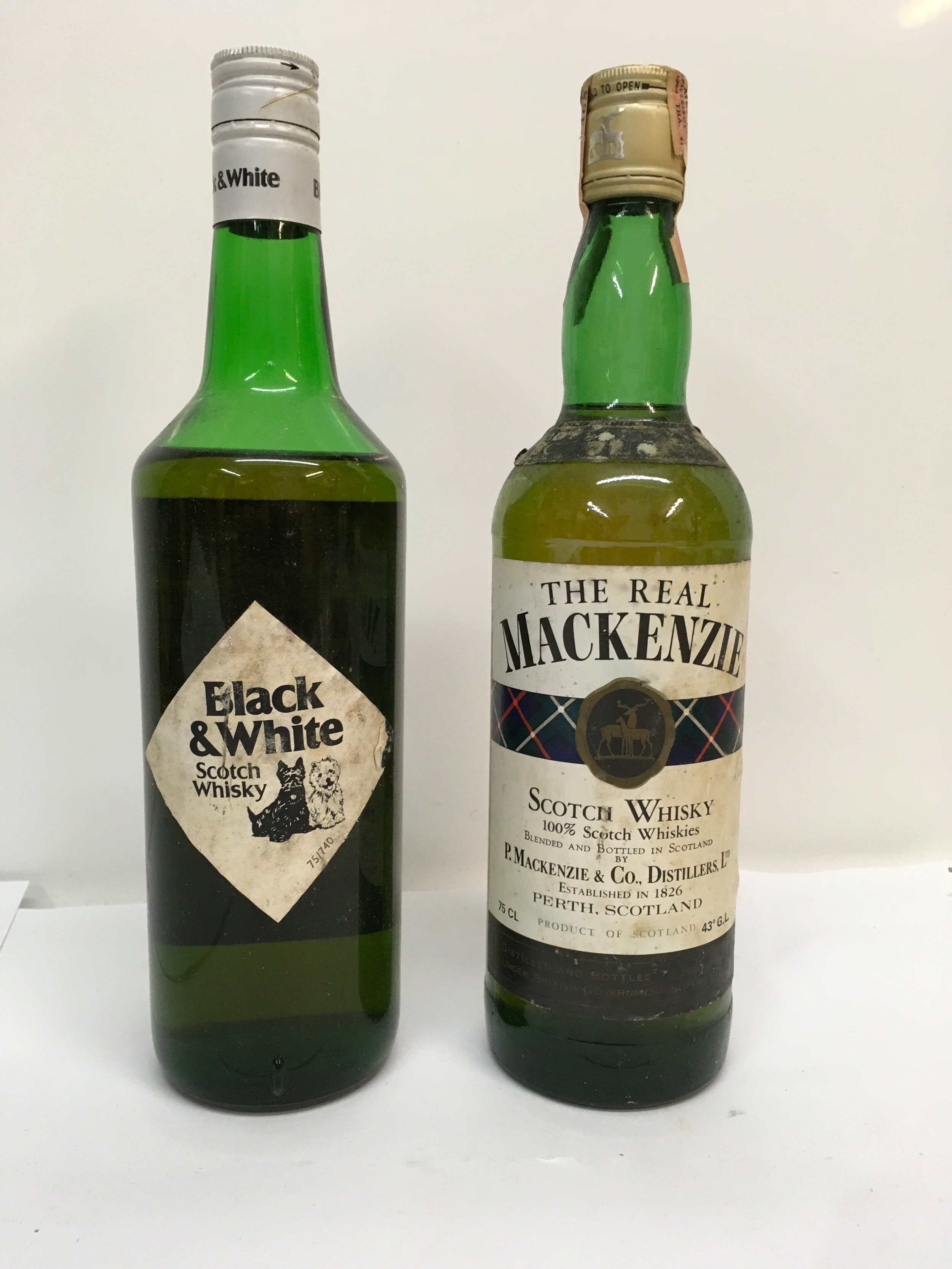 Two bottles of scotch whisky, 'The Real MacKenzie' and 'Black & White'