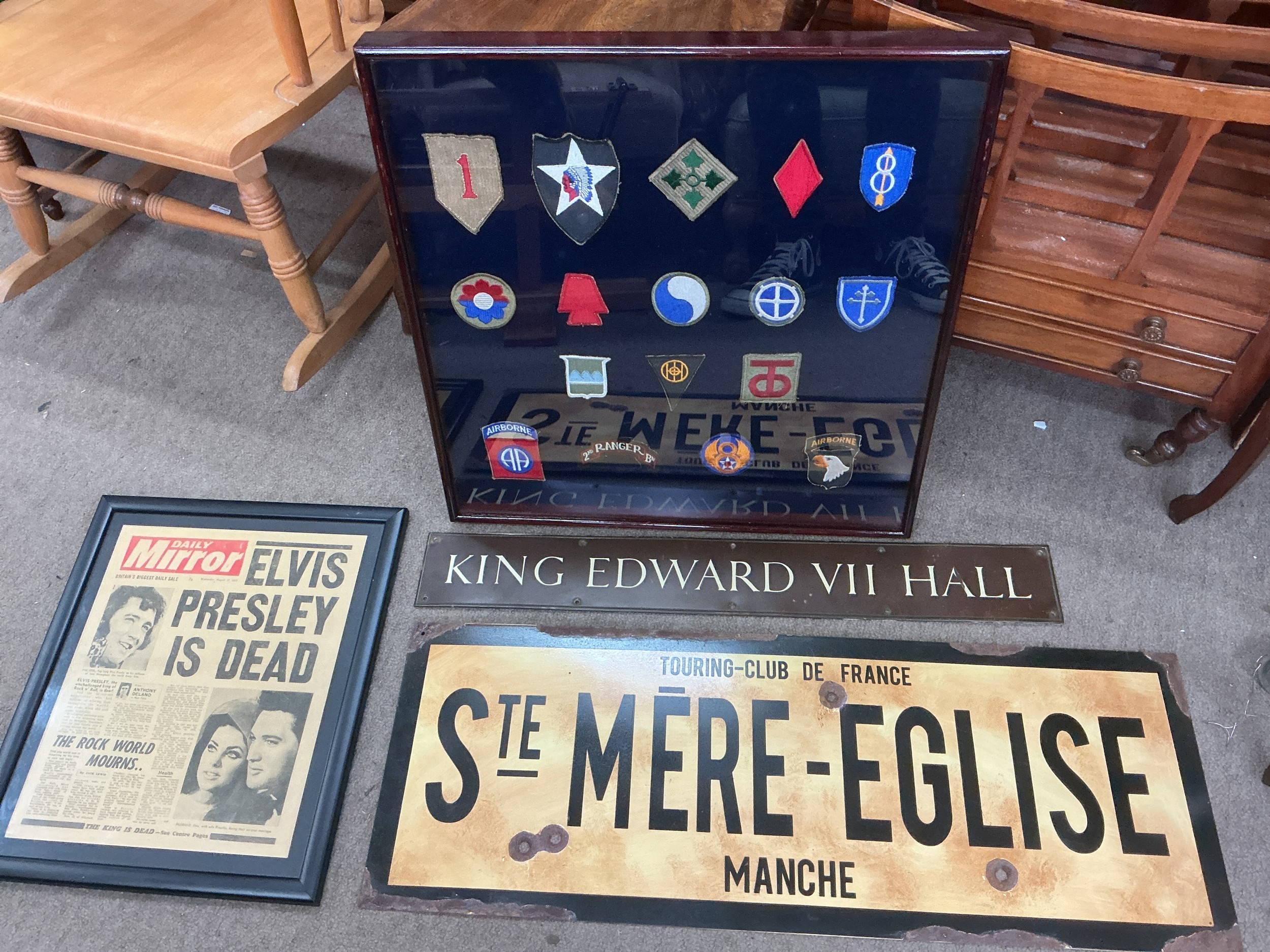 An enamel sign for Tourung Club De France pus a metal King Edward VII sign, framed military badges and a framed Daily Mirror from the day Elvis Presley died (4).